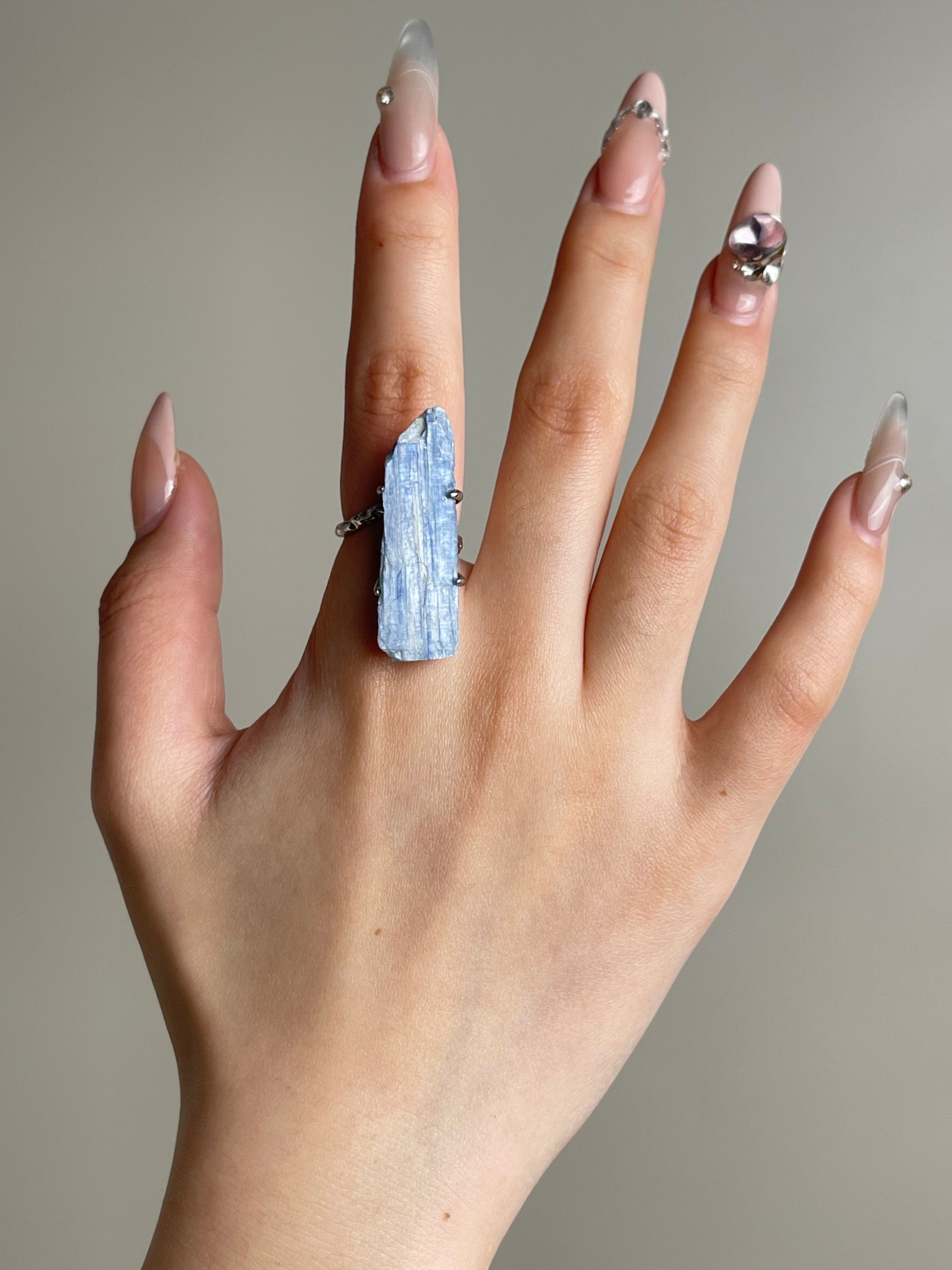 Blue kyanite mineral specimen ring worn on hand in silver tone finish
