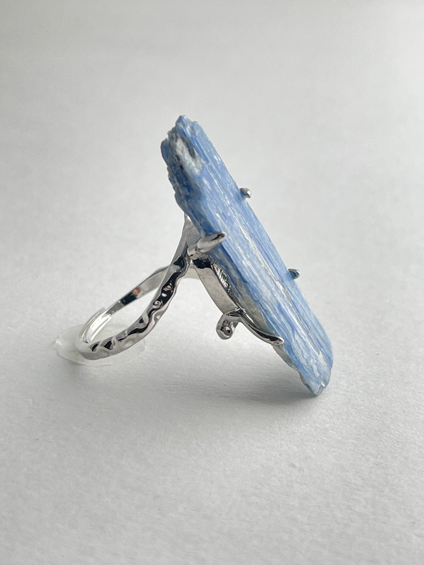 Side view of blue kyanite mineral specimen ring with adjustable open band