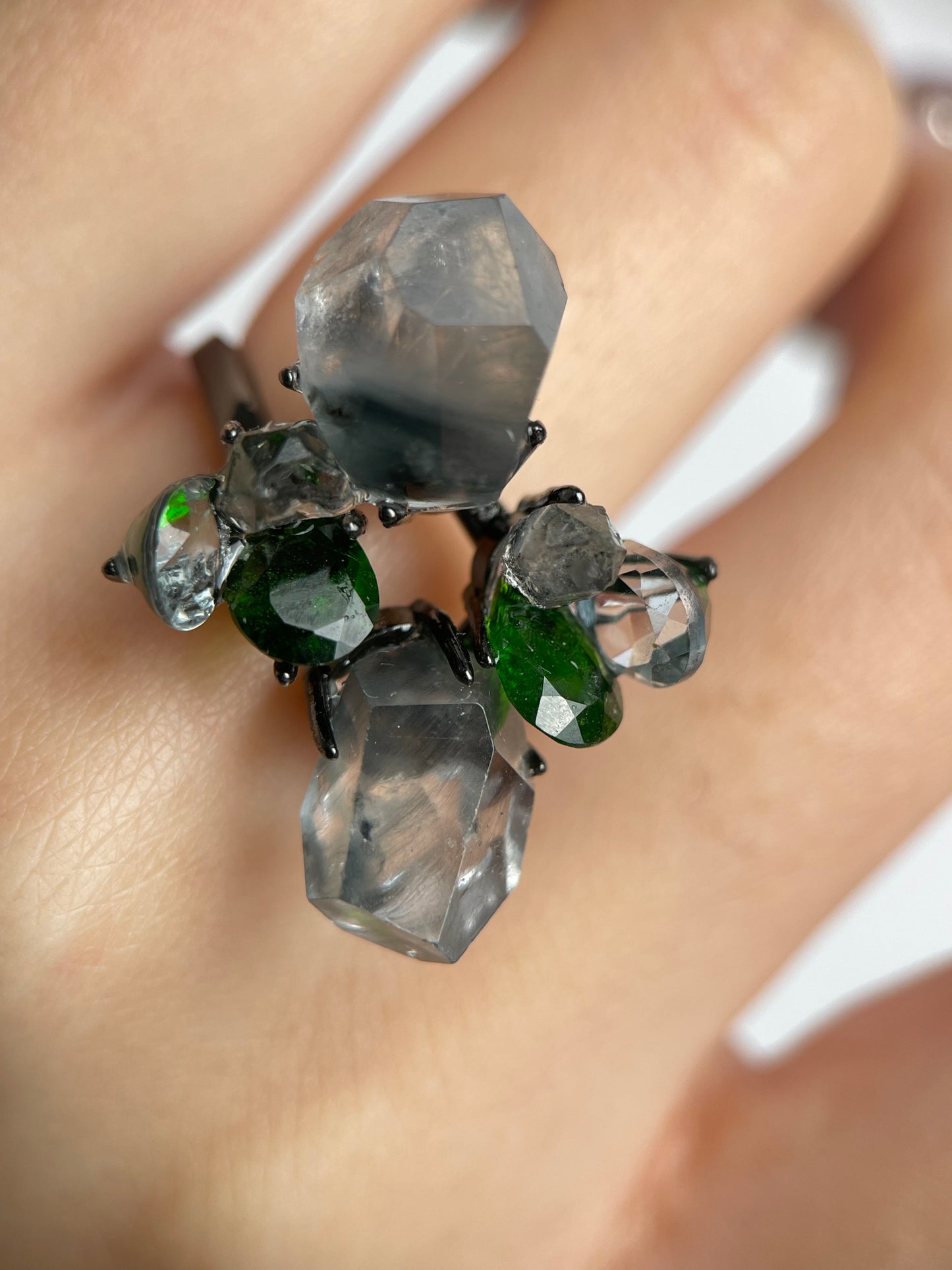 Close-up of Blue Rutilated Quartz Ring worn on hand with Hakima Diamond Quartz and Chrome Diopside