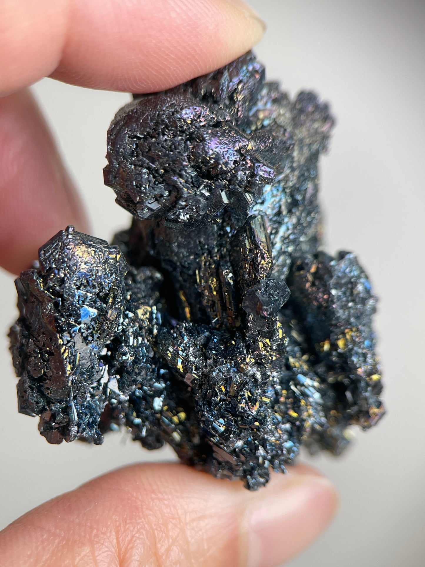 Detailed view of Carborundum cluster showing sharp crystal formations, metallic surface texture, and colorful light reflections.