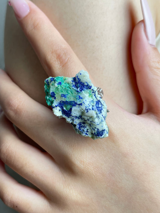 Close-up hand view of chalcopyrite with malachite and quartz mineral specimen ring.