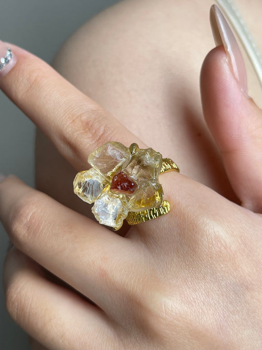 Close-up hand shot of Citrine and Garnet Flower Ring by Oryssia