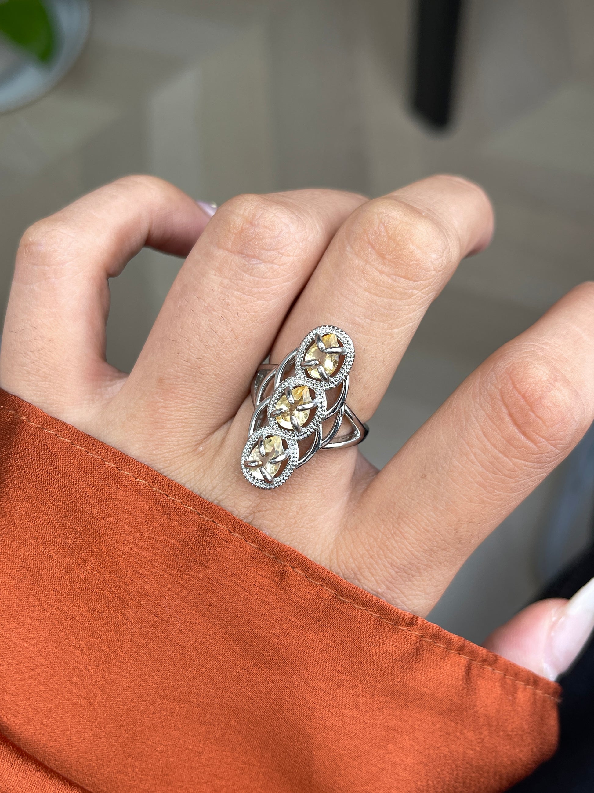 close up of citrine pear cut ring showing golden light reflection