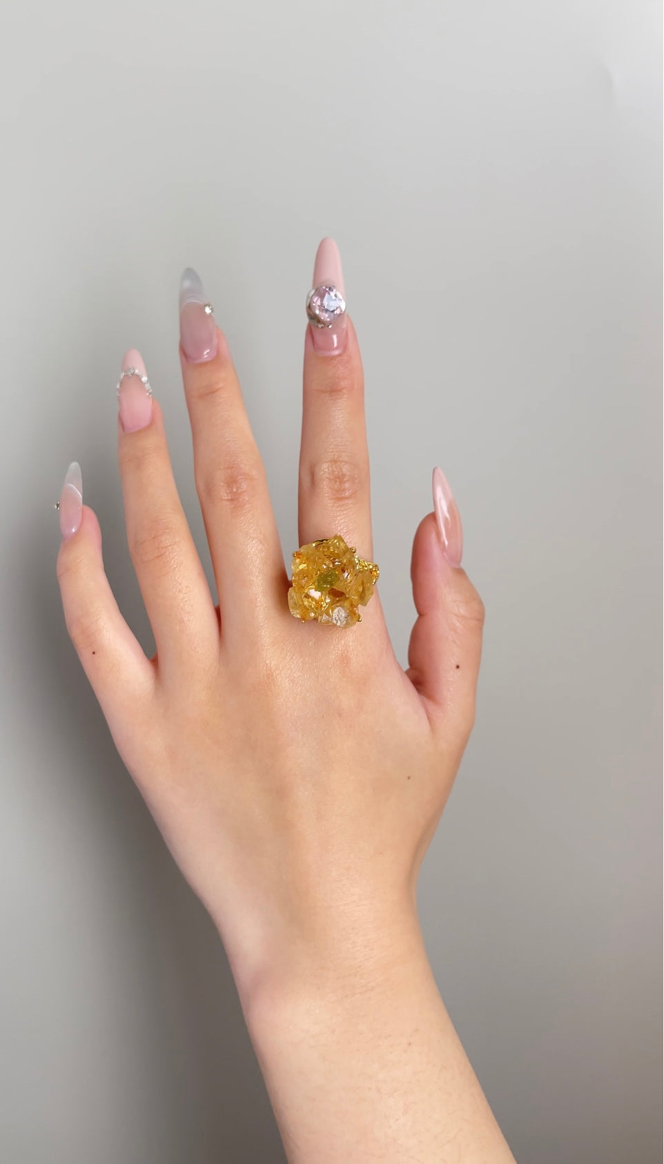 citrine peridot crystal blossom ring worn on hand
