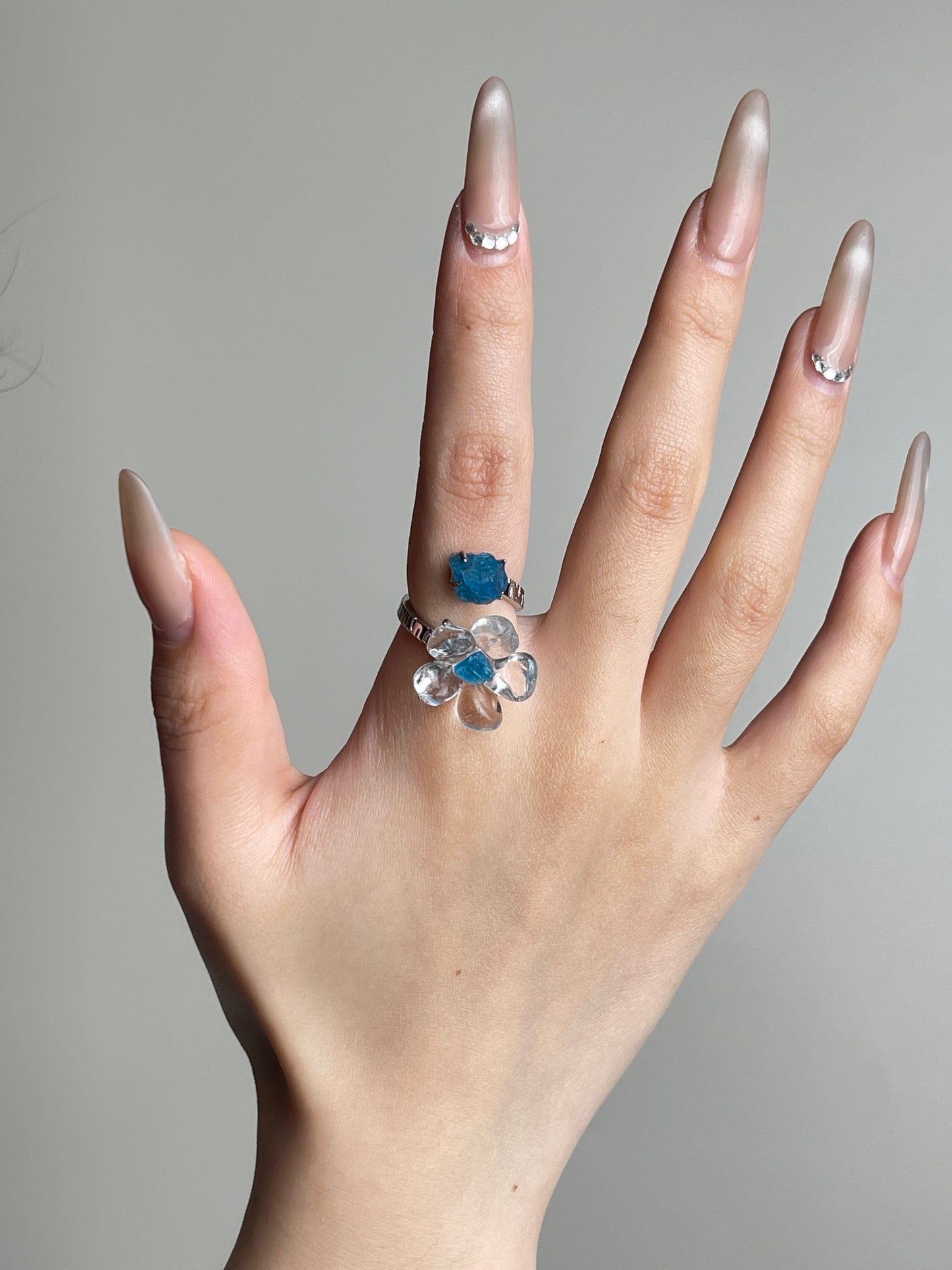 Hand view of Clear Quartz Flower Ring with raw Blue Apatite