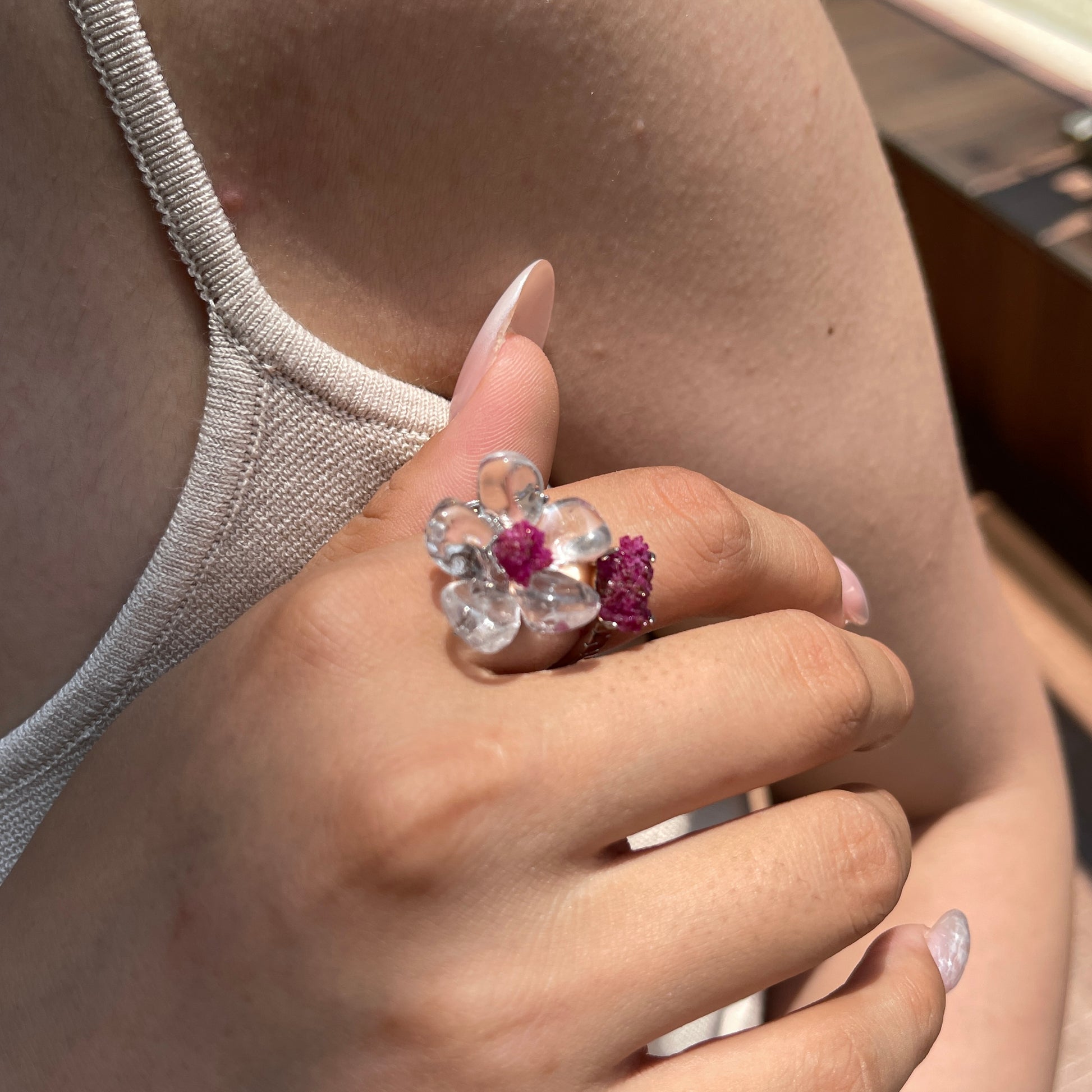 Close-up hand view of Clear Quartz Flower Ring with raw Ruby