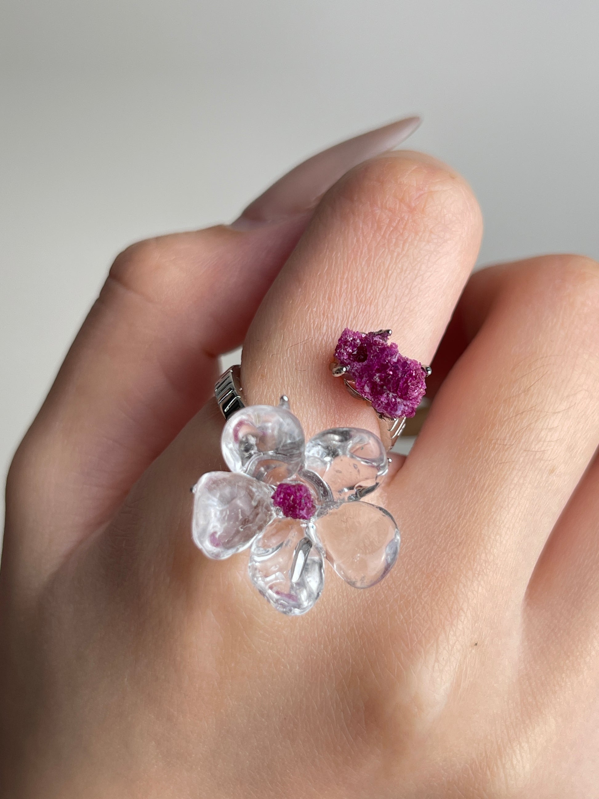Close-up hand view of Clear Quartz Flower Ring with raw Ruby