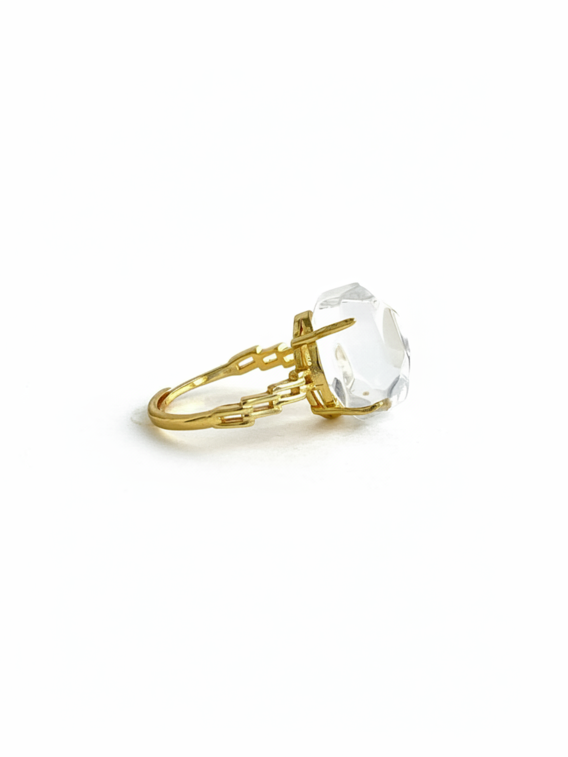 Side view of a Clear Quartz freeform ring showing the raised transparent crystal centerpiece and gold tone band structure