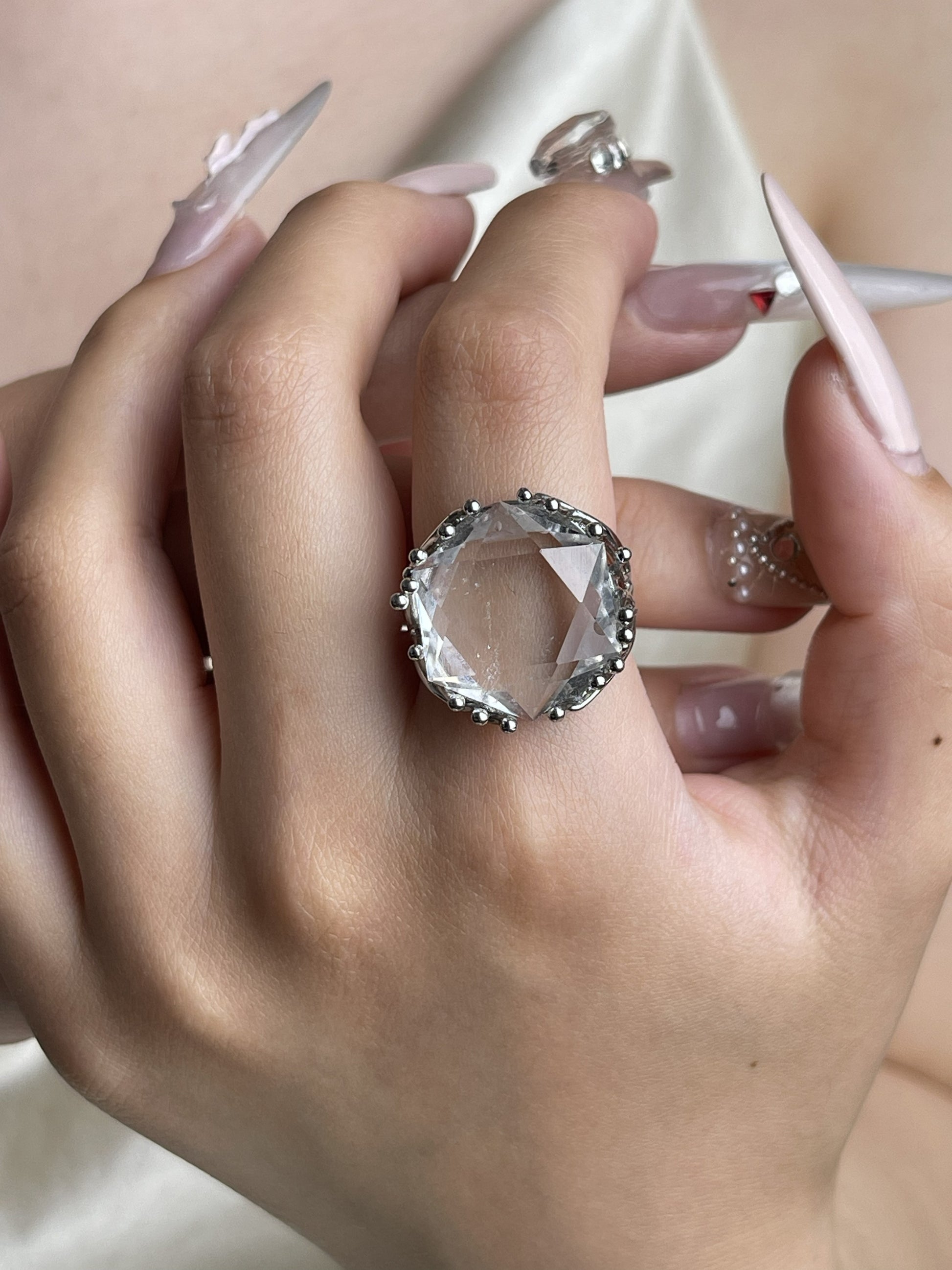 Clear quartz geometric ring hand detail