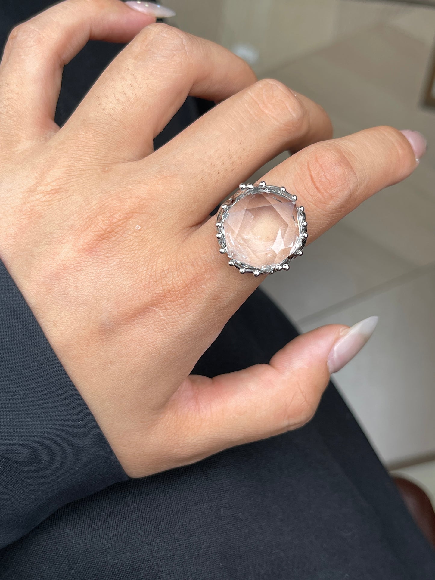 Clear quartz six point ring worn on hand