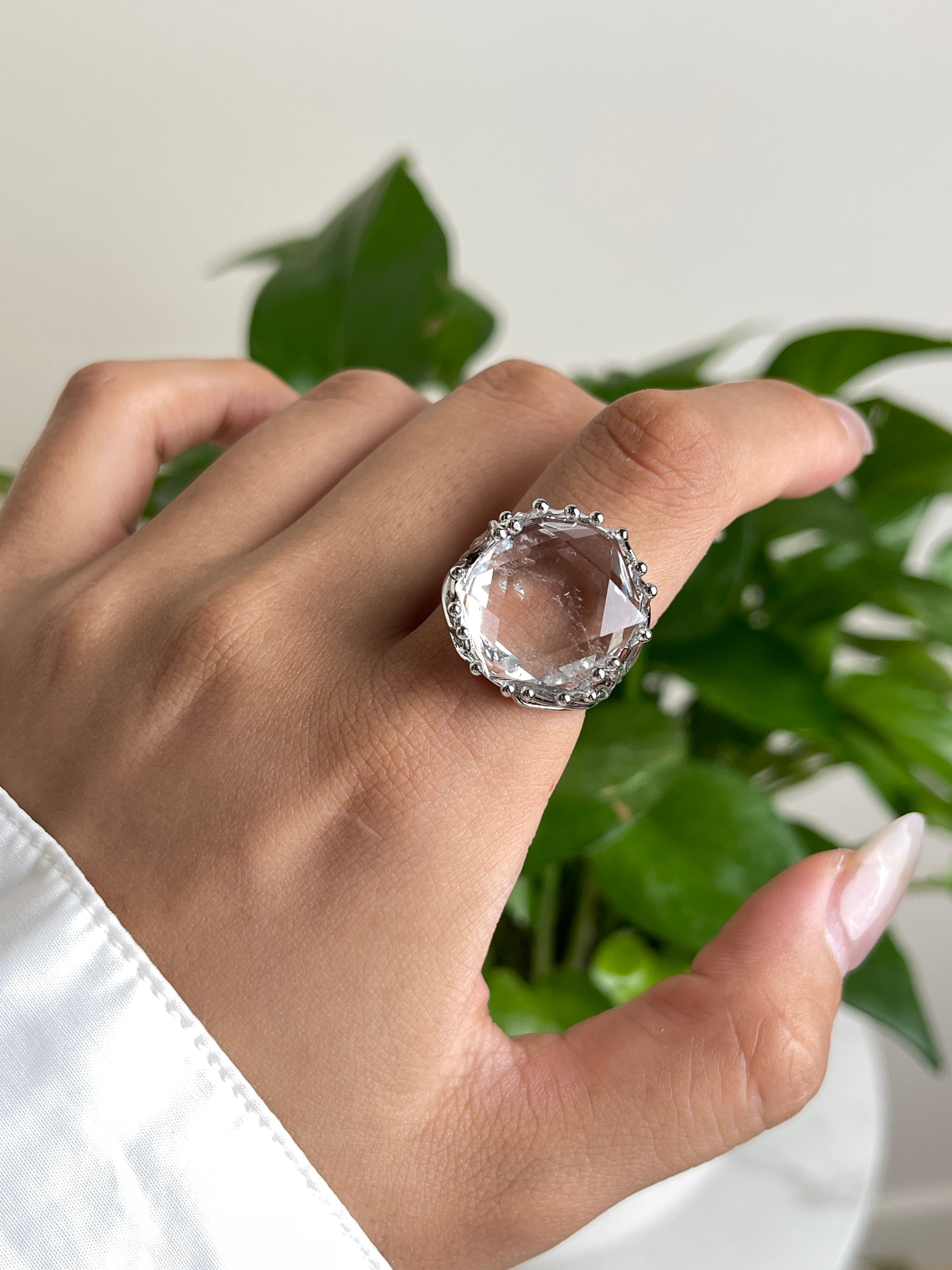 Clear quartz six point ring worn on hand