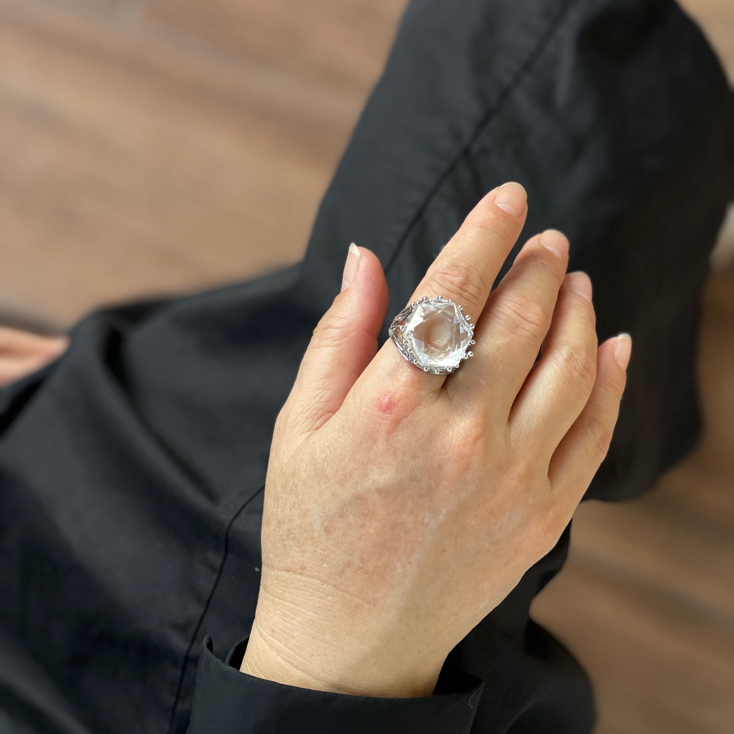 Clear quartz six point ring worn on hand