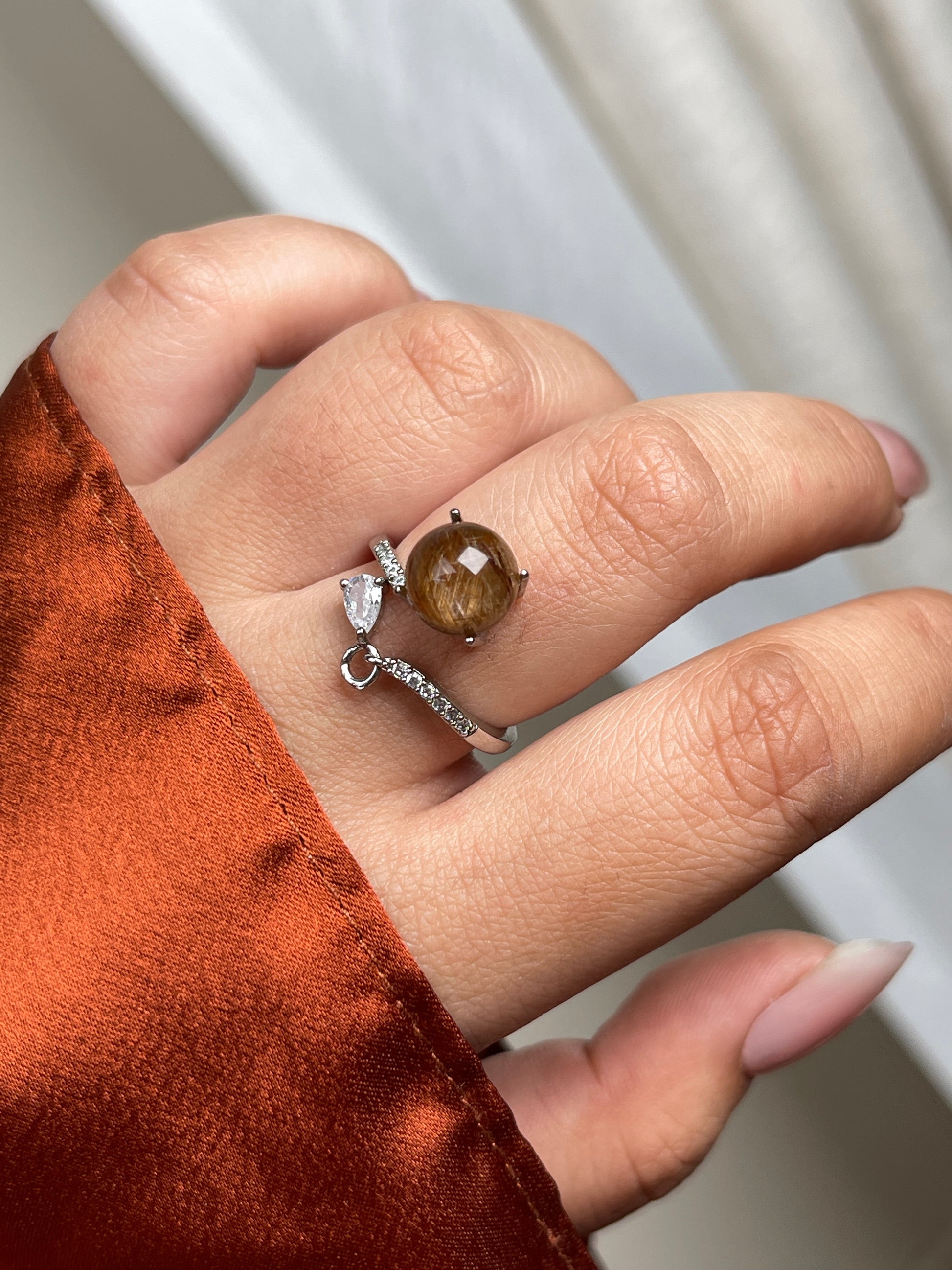 Close-up of copper rutilated quartz ring with fine needle-like inclusions