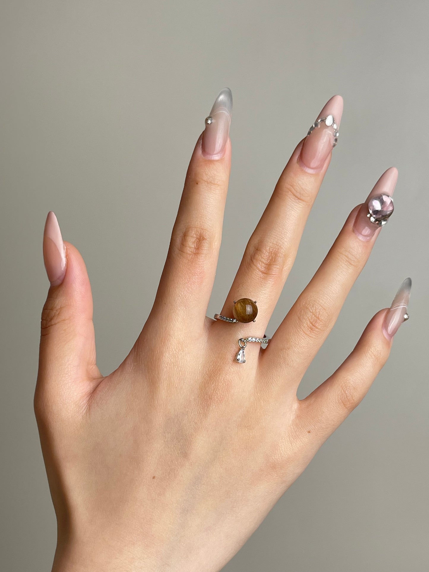 Copper rutilated quartz ring worn on hand with natural golden inclusions