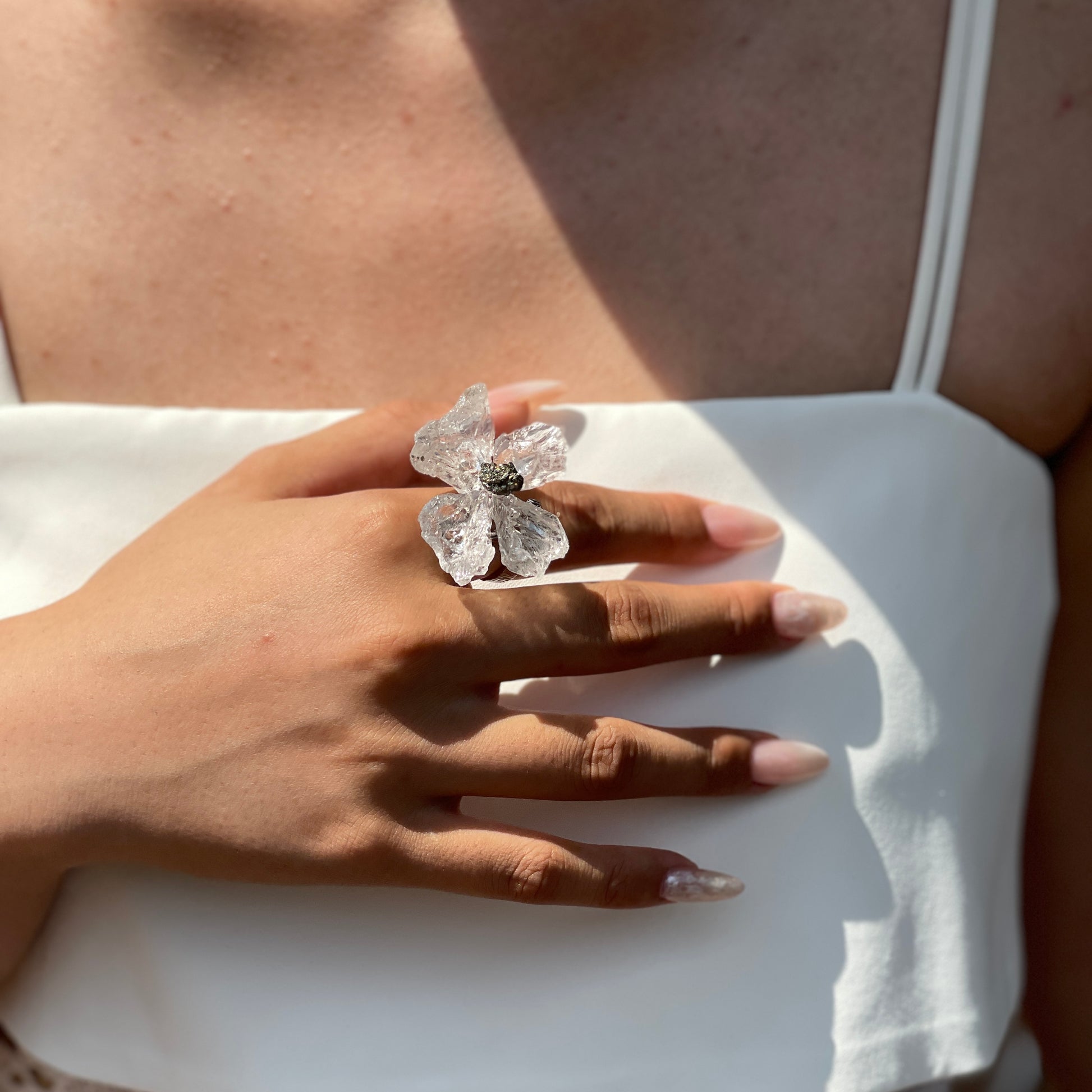 Close-up of Crystal Butterfly Ring worn on hand with Brazilian Quartz and Peruvian Chalcopyrite