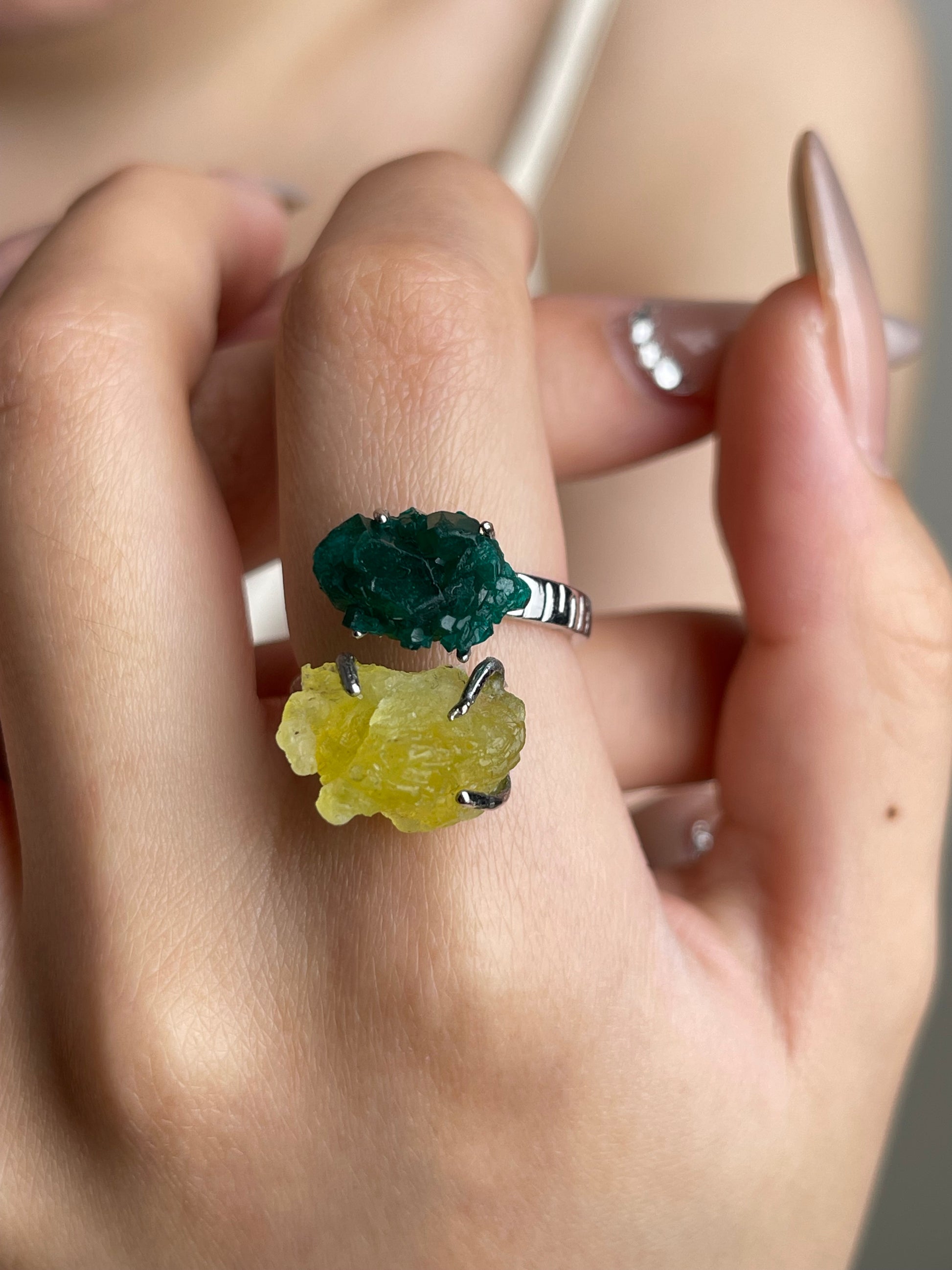 Close-up hand shot of Dioptase and Brucite mineral specimen ring