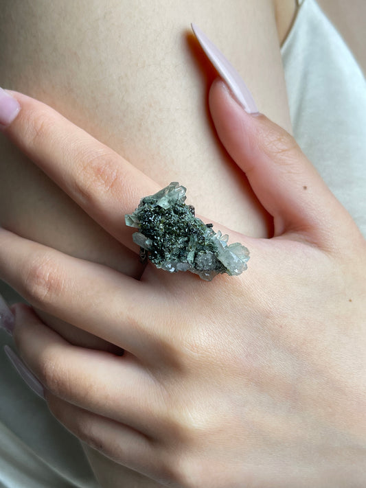 Close-up hand wearing Epidote and Quartz crystal cluster ring