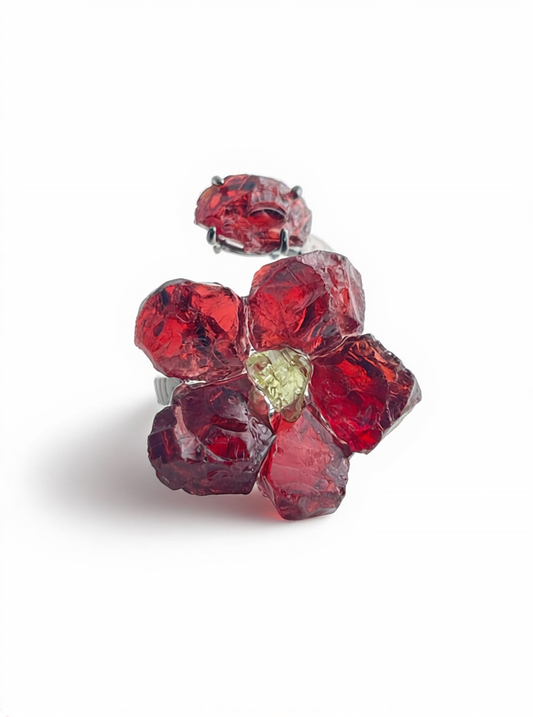 Garnet flower ring with peridot center front view in black rhodium finish
