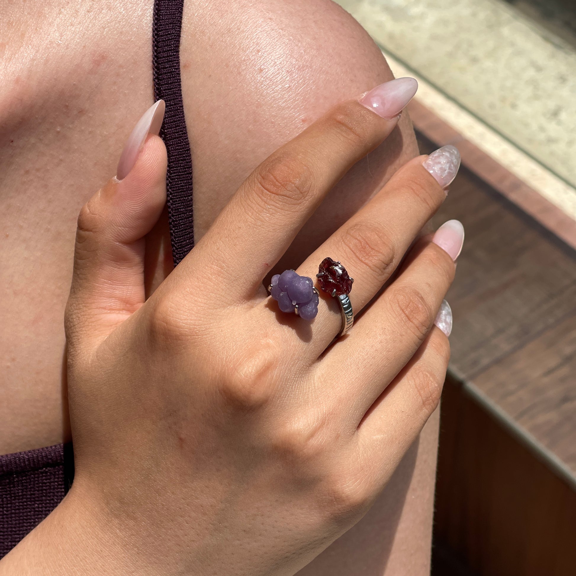 Close-up hand wearing raw Garnet and Purple Grape Agate ring