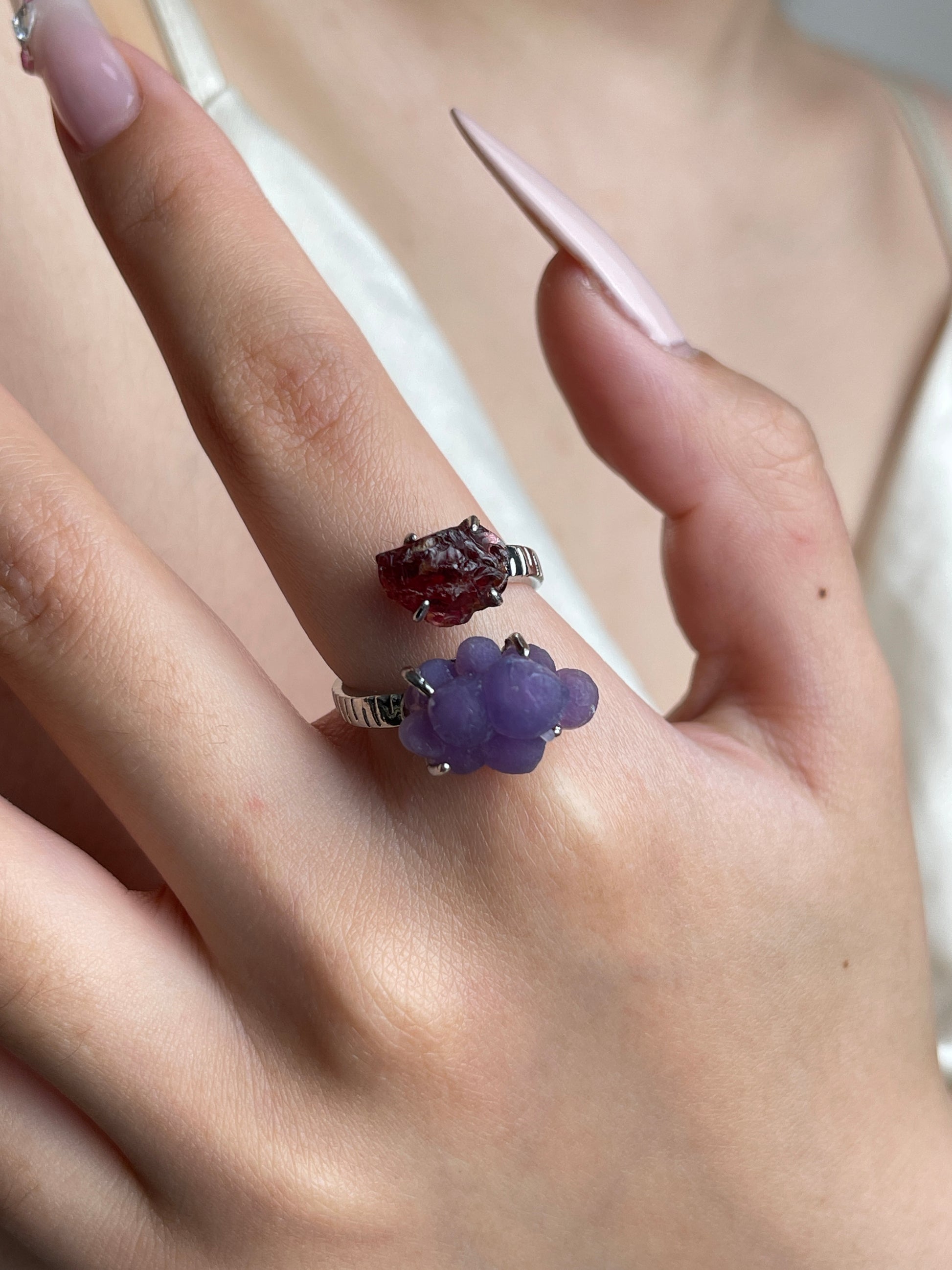 Close-up hand wearing raw Garnet and Purple Grape Agate ring