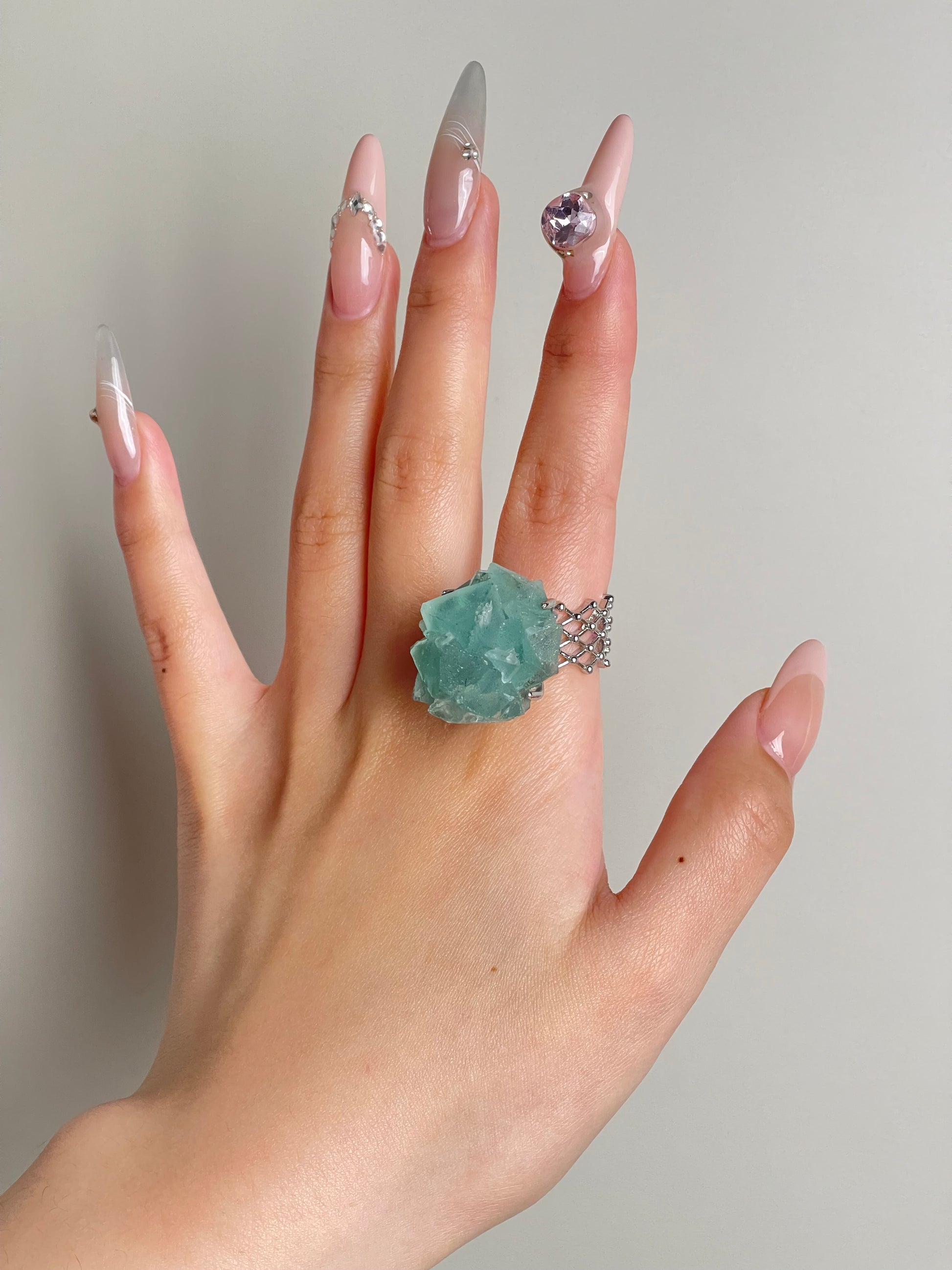 green fluorite octahedral crystal ring worn on hand