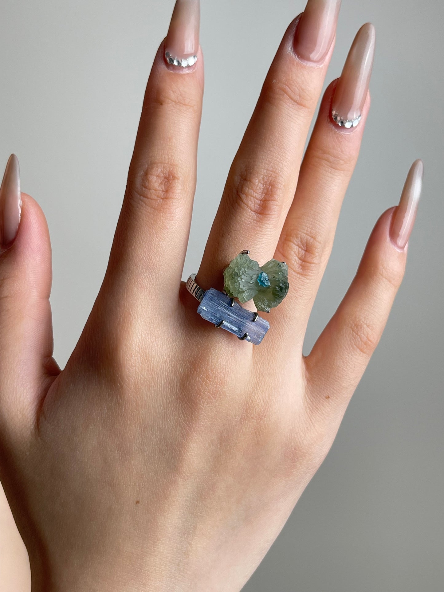Green Prehnite Blue Apatite and Kyanite bow ring worn on hand