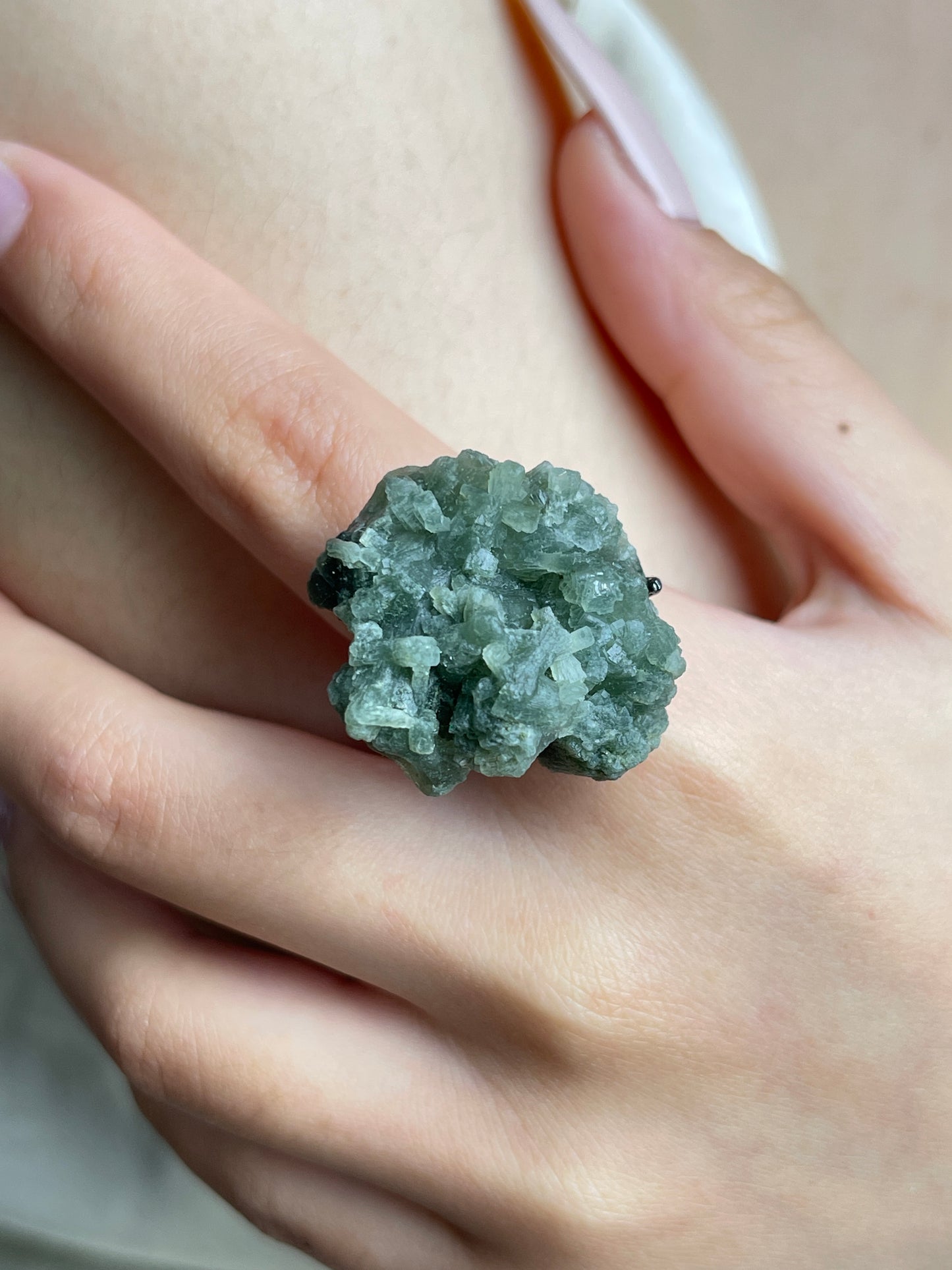 Close-up hand wearing Green Prehnite mineral specimen ring