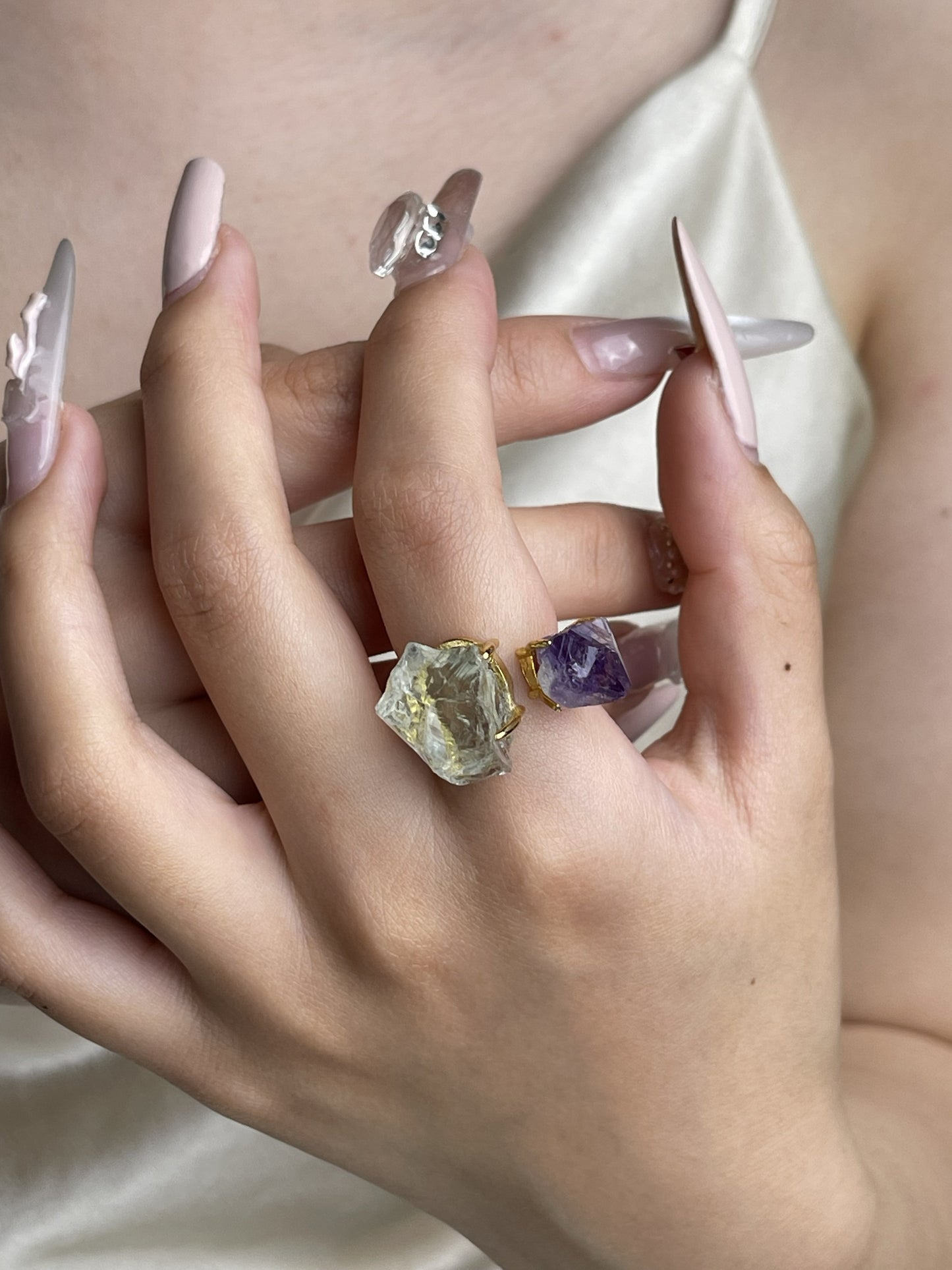 Raw Green Quartz and Amethyst crystal ring worn on hand