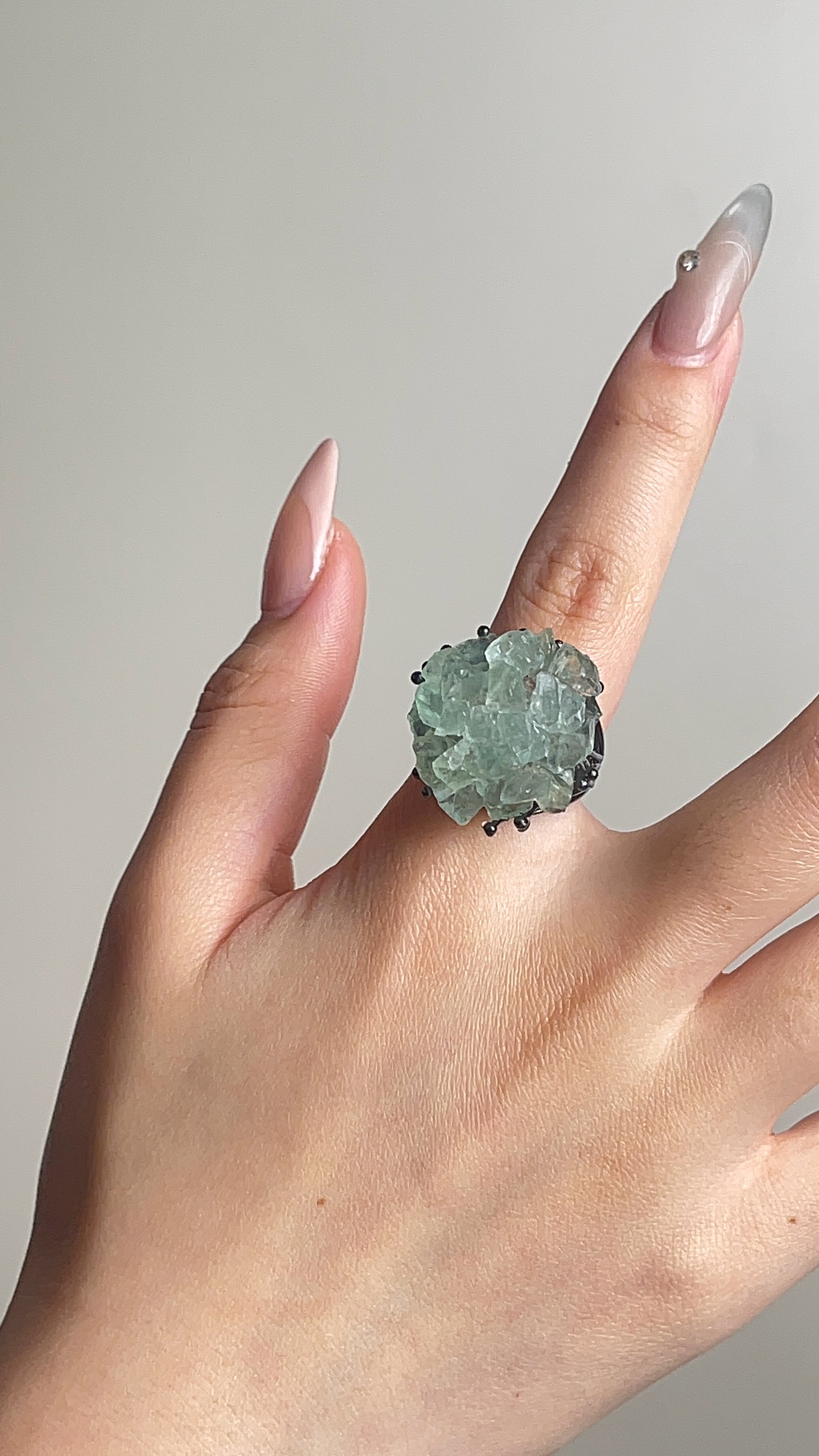 green quartz crystal cluster ring worn on hand