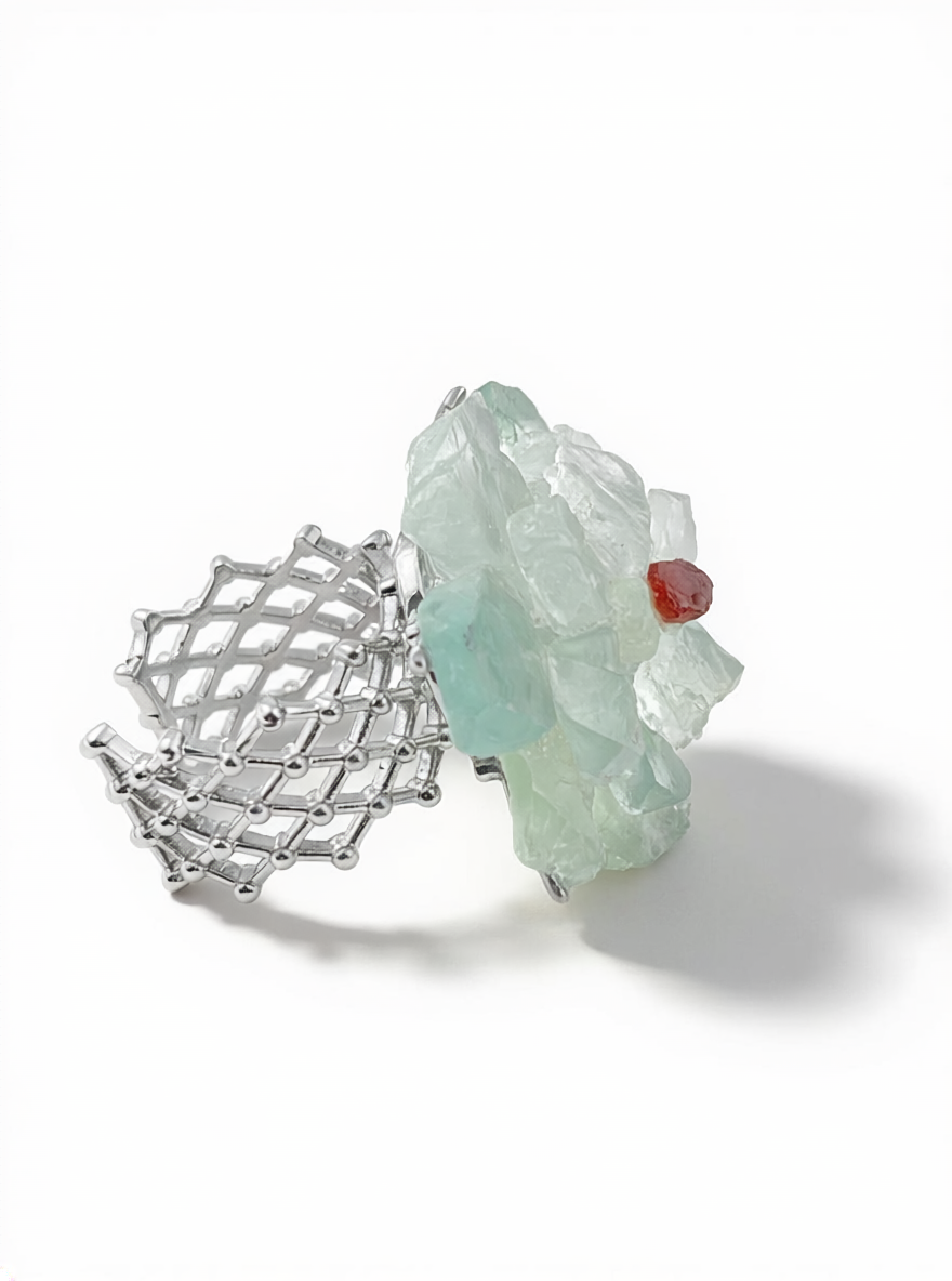 Side view of green quartz and garnet flower ring with adjustable band