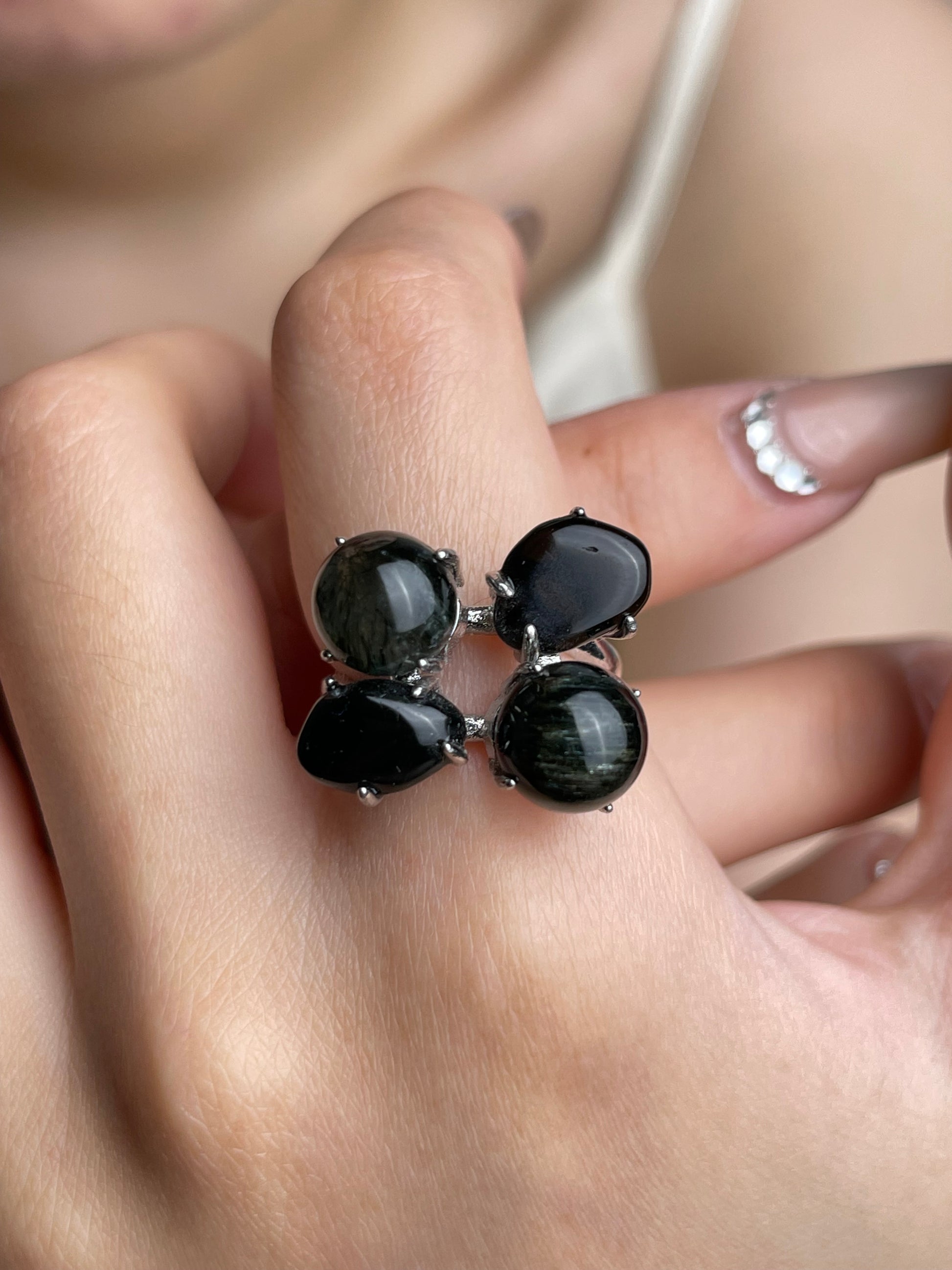 Close-up hand shot of Green Rutilated Quartz and Smoky Quartz ring