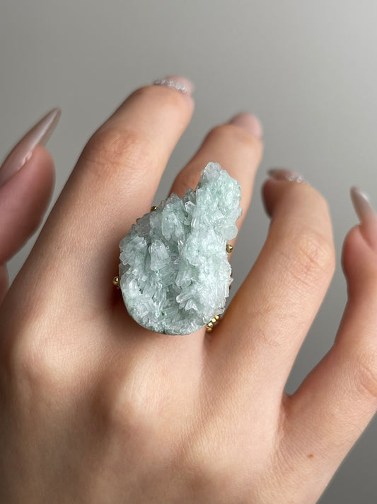 Close-up hand shot of green strawberry quartz ring