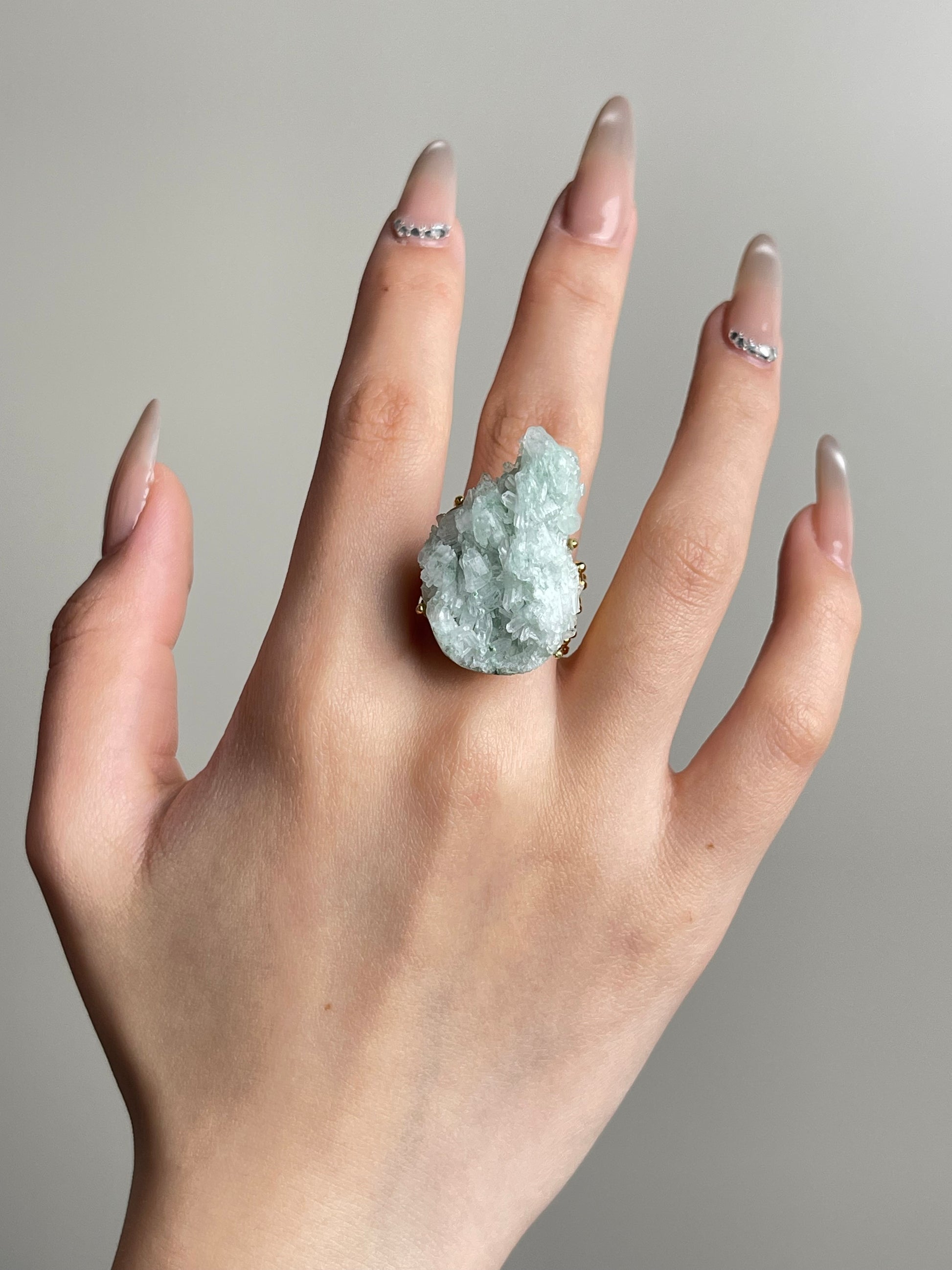Hand shot of green strawberry quartz ring