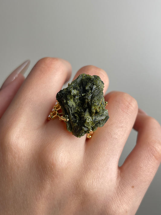 Close-up hand shot of green tourmaline cluster ring