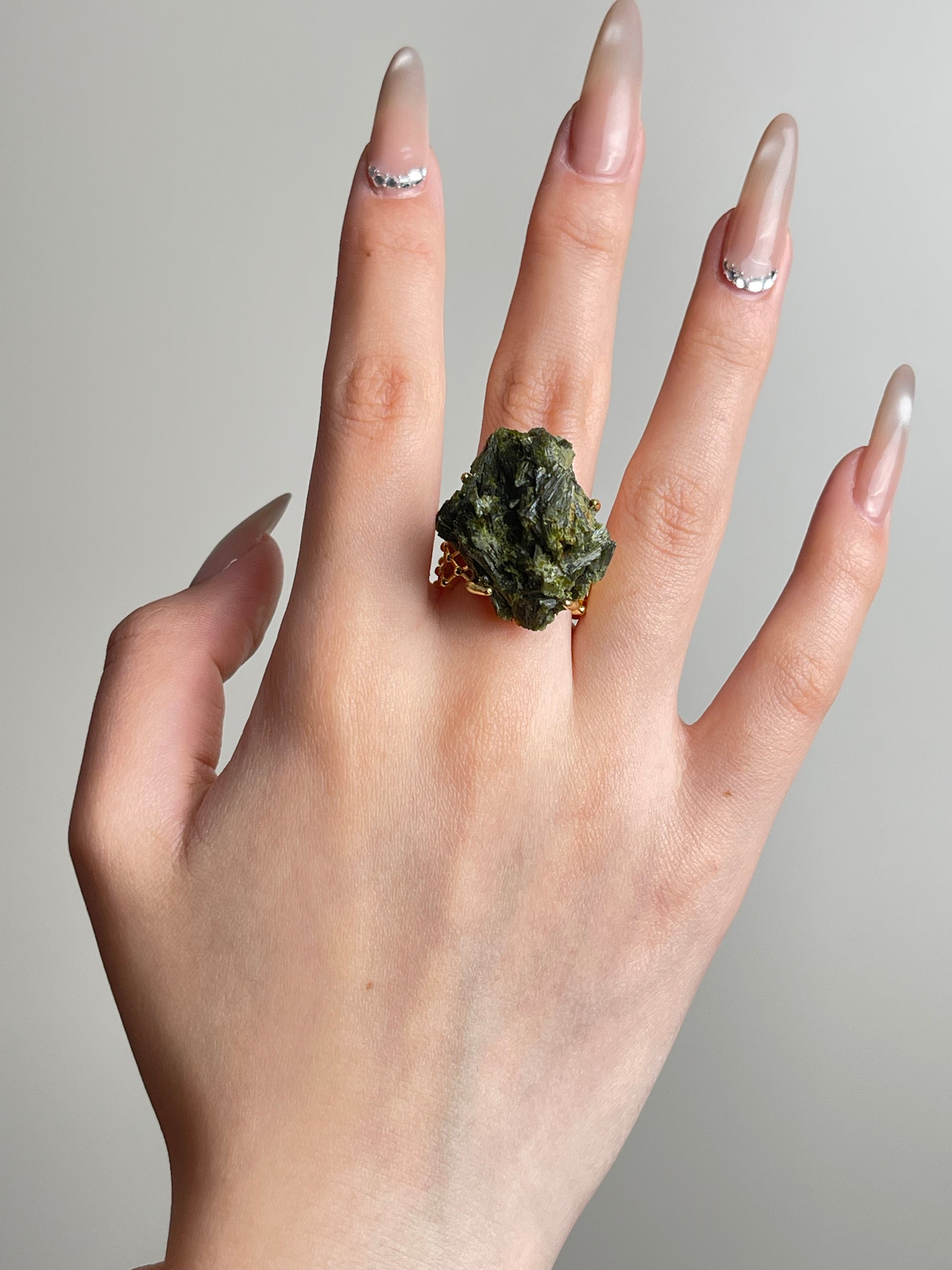 Hand shot of green tourmaline cluster ring
