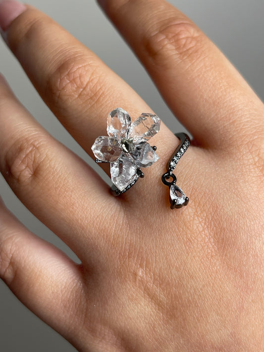 Close up of Hakima Diamond Quartz and Chalcopyrite flower ring on hand
