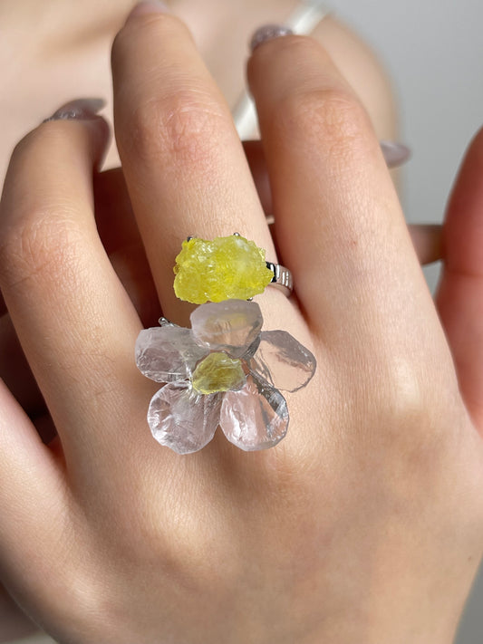 Close-up hand shot of hand-carved Rose Quartz flower ring with Brucite