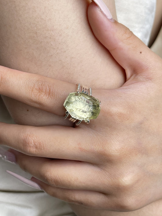 Close-up hand shot of hand-cut citrine ring showing golden quartz clarity and silver tone band