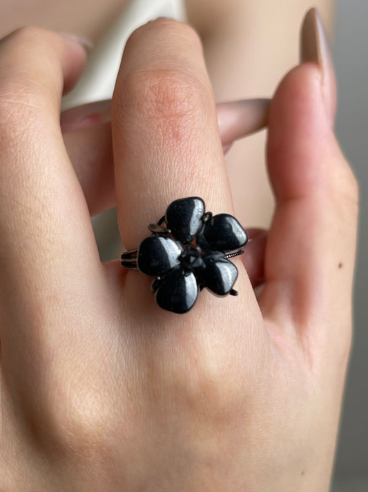 Close-up hand shot of Hematite flower ring with Herkimer Diamond Quartz