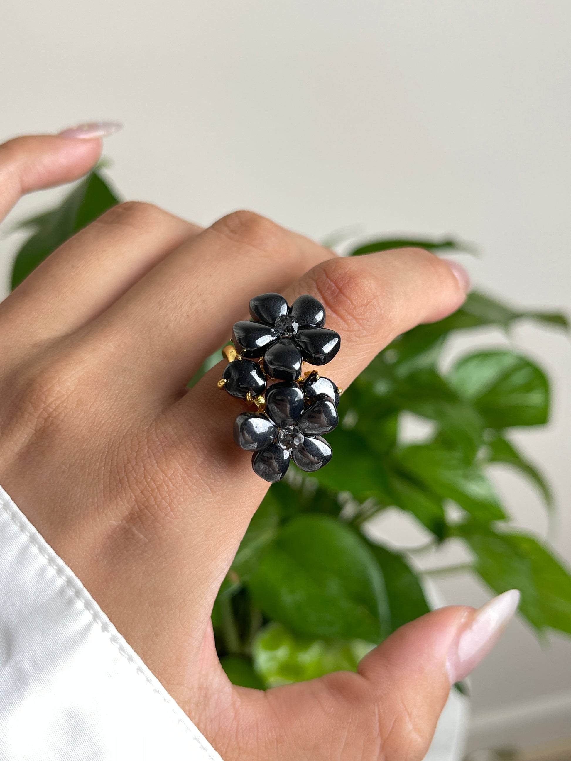 macro view hematite blossom ring with herkimer diamond quartz