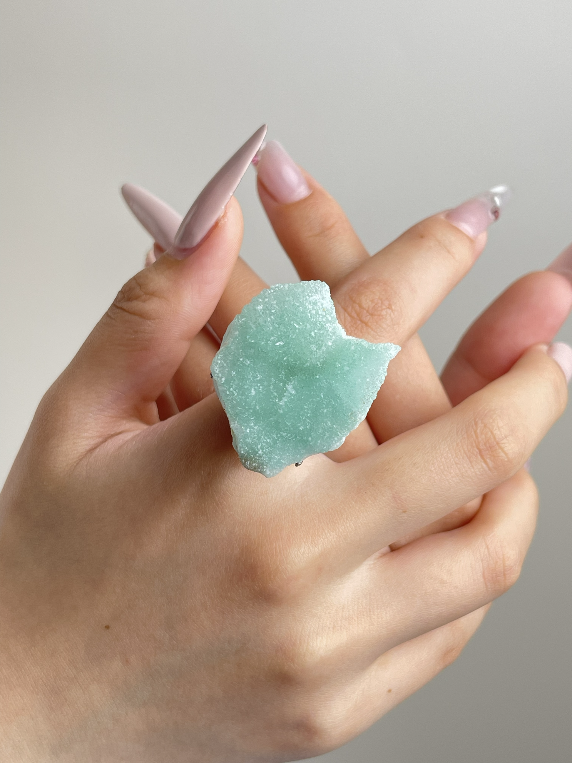 Hemimorphite crystal ring worn on hand in silver tone