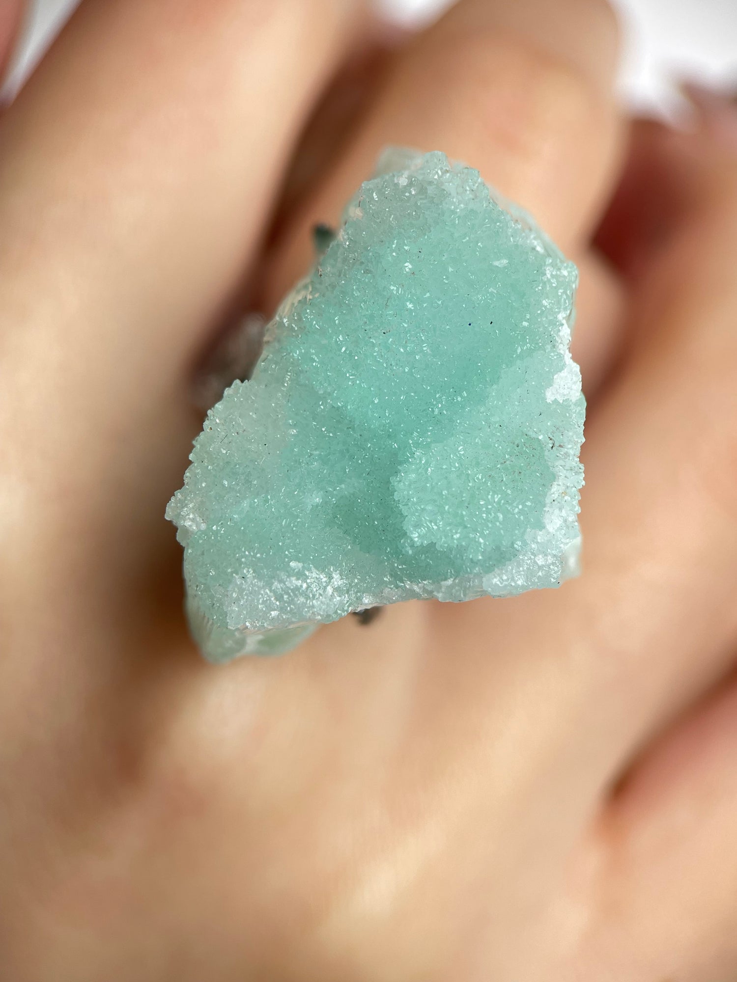 Close-up of hemimorphite ring showing fine crystal texture and natural surface