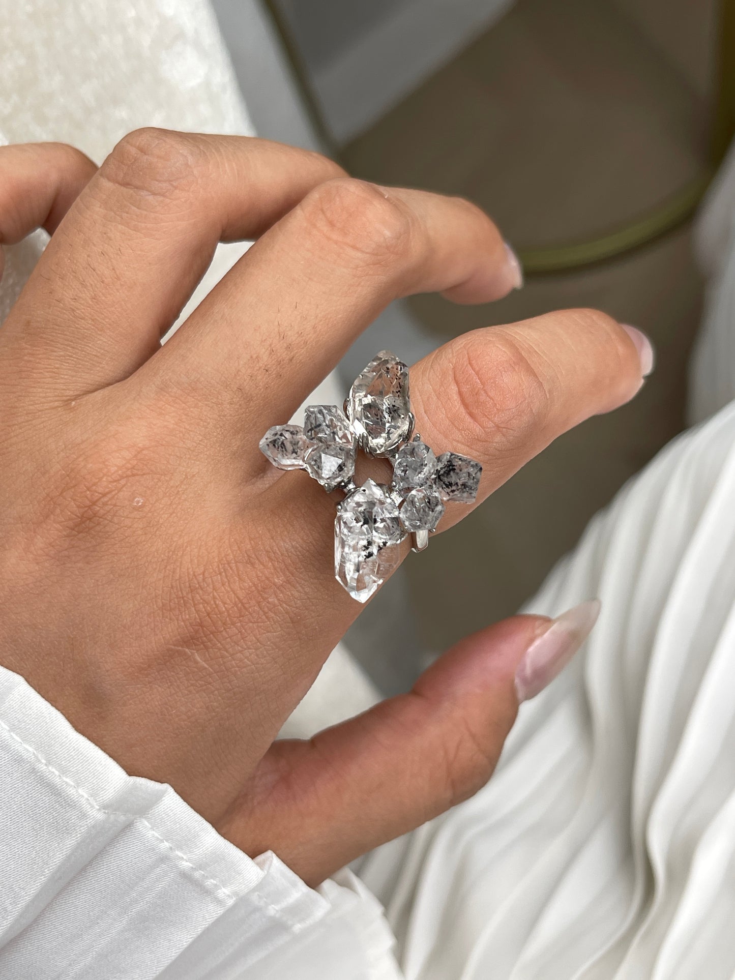 Close-up hand view of Herkimer Diamond Quartz four stone ring