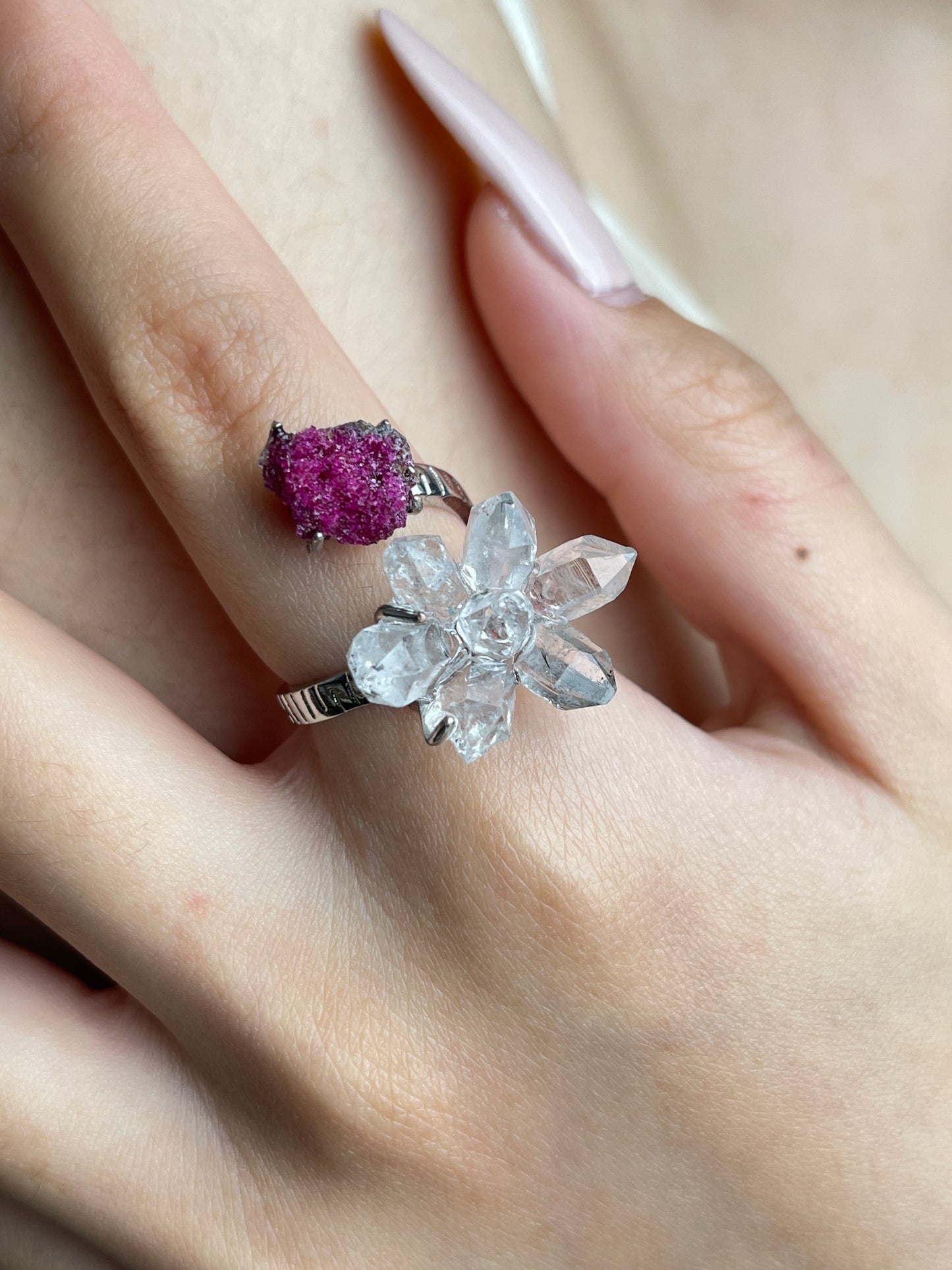 Close up of Herkimer Diamond Quartz and ruby ring on hand