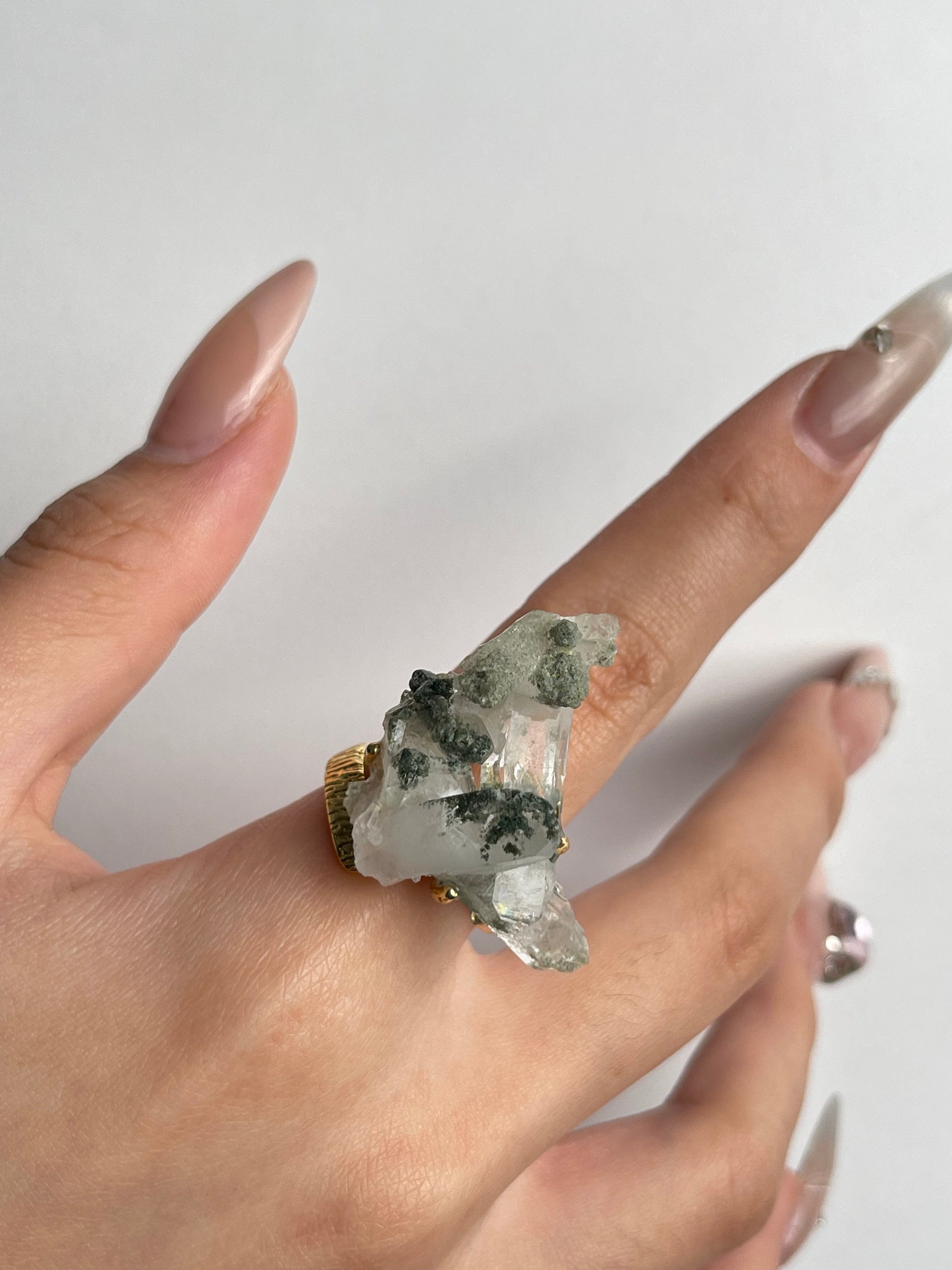 macro view himalayan chlorite quartz crystal ring on hand
