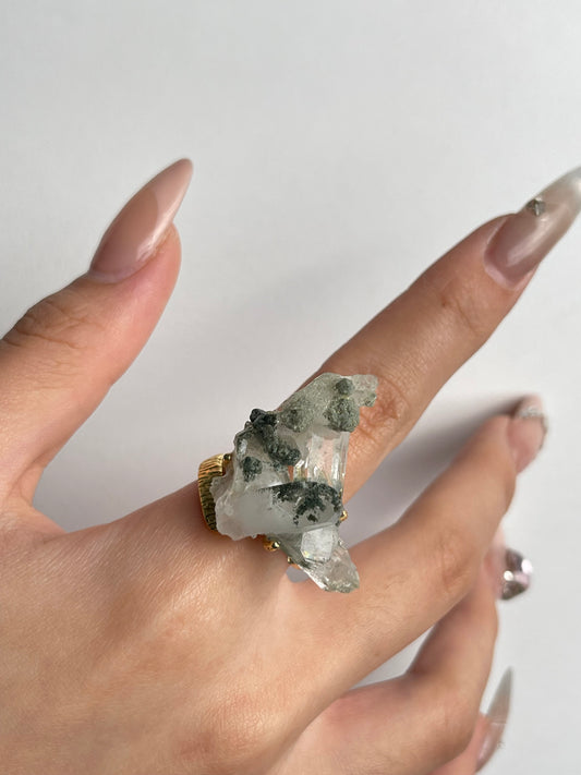 macro view himalayan chlorite quartz crystal ring on hand