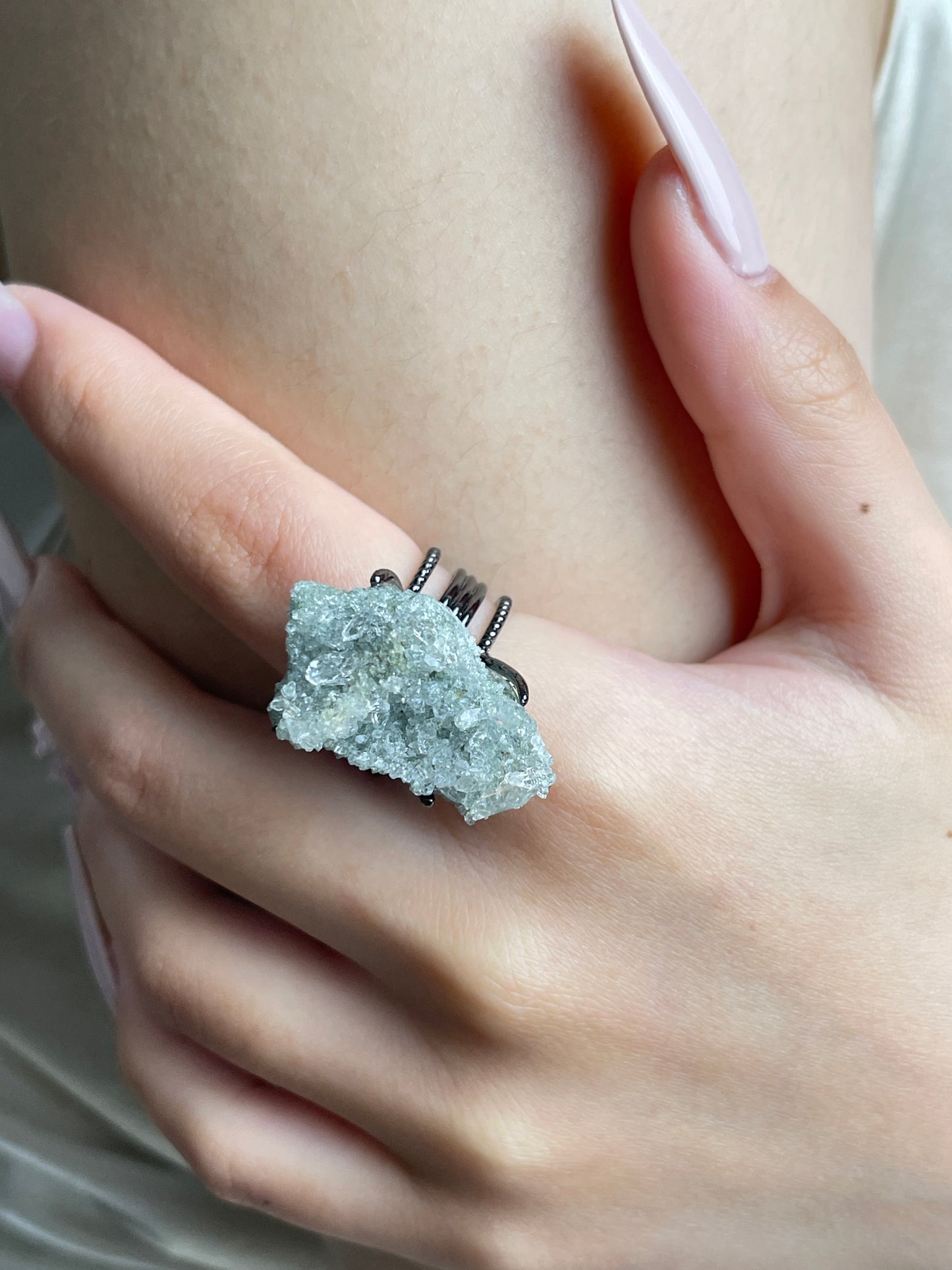 Close-up hand wearing Himalayan Green Phantom Quartz cluster ring