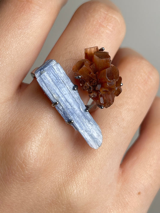 Close up of kyanite and aragonite cluster raw crystal ring worn on hand