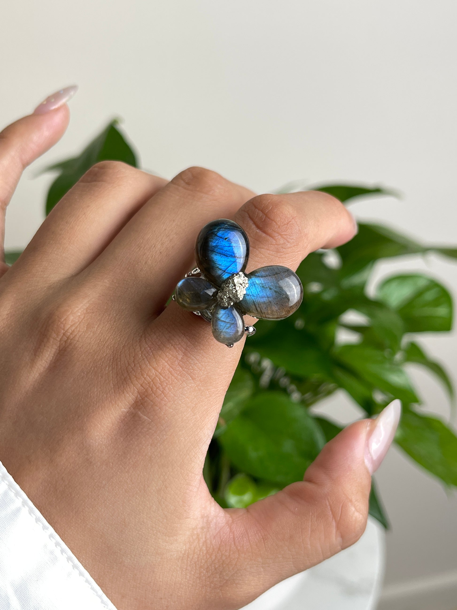 Close-up hand view of Labradorite Butterfly Ring with raw Chalcopyrite