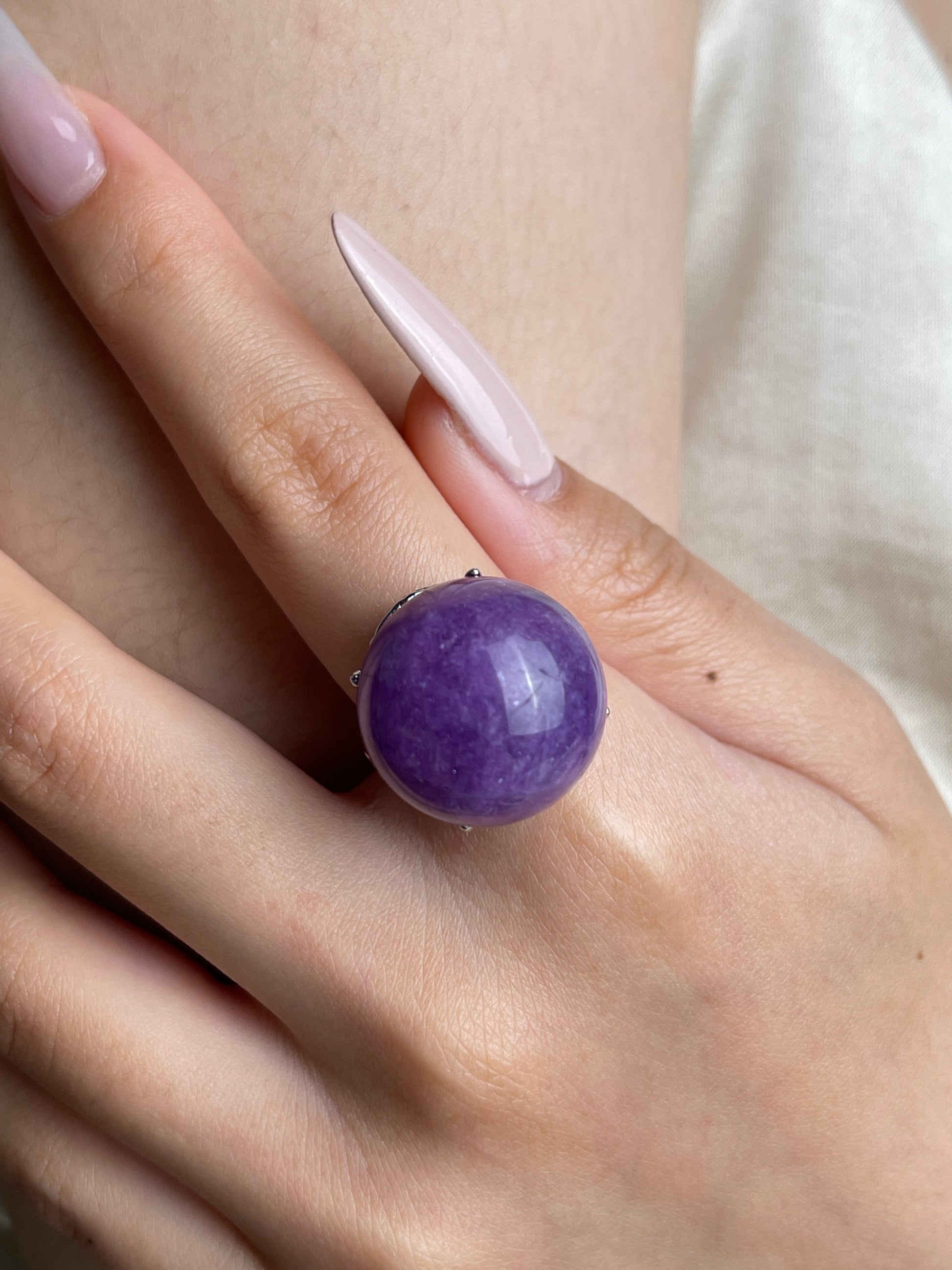 Close up of Lilac Lepidolite dome ring on hand